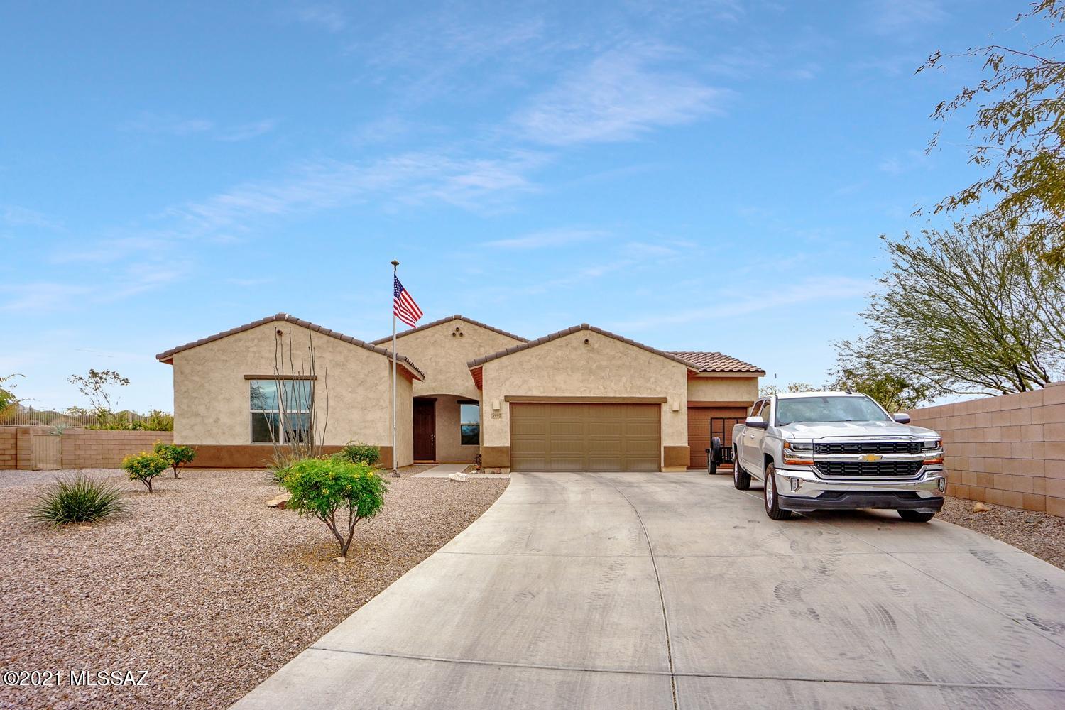 Come see this immaculate 3 bedroom home with office offering privacy, views, a premium lot, drive-thru 3 bay garage, huge walk-in closets and split bedroom floor plan. Located close to wildlife corridors and the Santa Cruz River with easy I-10 access, abundant shopping, restaurants, golf, hiking, biking the location is hard to beat.  For the home owner that's always on the go, being part of a small gated community with low maintenance landscaping offers a ''lock and go'' benefit and security.   
Houses in this community don't come on the market very often and don't last long, so come visit and see all this home has to offer, then enjoy the gorgeous Tucson Mountain sunsets from your own private back patio..