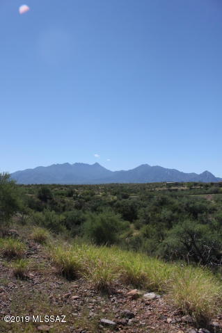 2 plus acre lot with unobstructed views of the Santa Rita's and Madera Canyon. Private, serene, neighborhood starting to fill with newly built custom homes.  Large building pad sits above a mesquite bosque and riparian area. All utilities at the curb and in a cul de sac too.