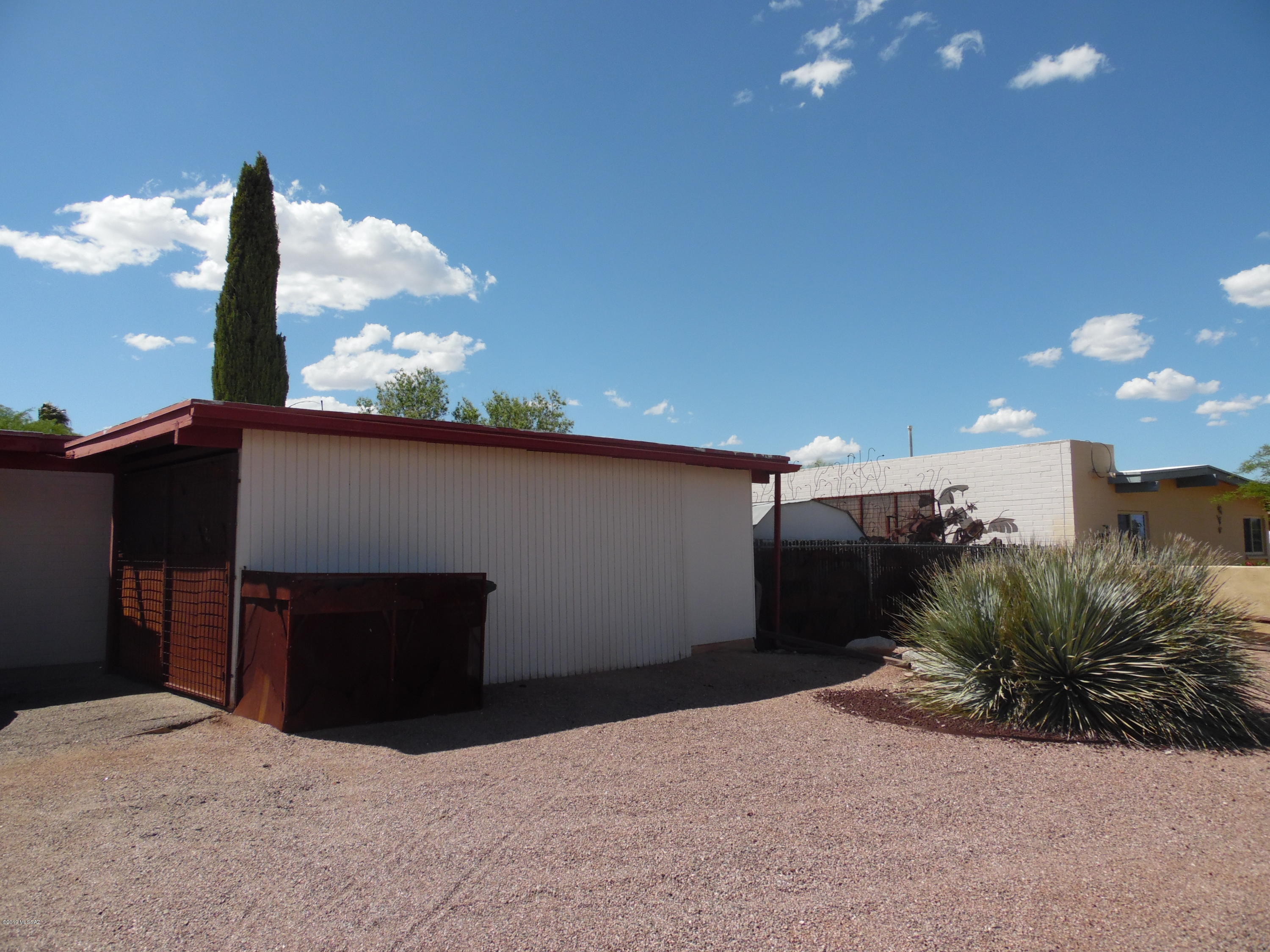 Spacious 2 bedroom 1 bath brick home with a large backyard.  Open great room, big kitchen and all tile throughout. This home is cooled by AC and has both washer and dryer hookups. The backyard has tons of space with two storage units for extra stuff.  The home is close to Davis Monthan, Fred Enke golf course, Pima East and shopping.  Call today!