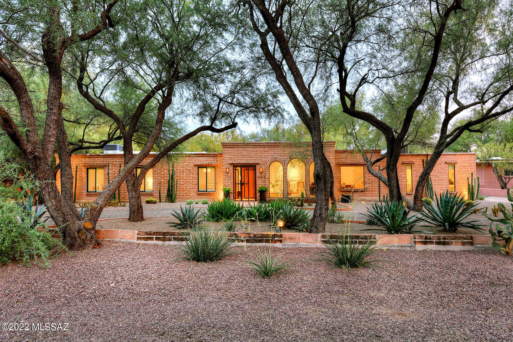 Beautiful Burnt Adobe Territorial canopied by a mature Mesquite Bosque, meticulously renovated and remodeled with extensive attention to both structural & cosmetic details.  Custom high-end plumbing & light fixtures, colored concrete floors, recessed lighting, large Cook's kitchen, center island, dual drawer beverage refrigerator, custom tiled back splash, cherry wood cabinetry, newer SS appliances, ECO by Cosentino counters, eat in area & attached great room;  Energy and water efficient fixtures. Formal living room & Dining room plus large separate recreation room. The primary bedroom enjoys a large walk in closet & remodeled bathroom.  2 & 3 bedrooms are ample and share the hall bathroom.  4th bedroom is a split bedroom w/ bathroom.  All Bedrooms have Elfa closets. Ceiling mounted USB power for cameras and other smart home devices.  Backyard has pool, turf, custom tree house, 2 storage rooms & a large carport. Sited on .35 acre.