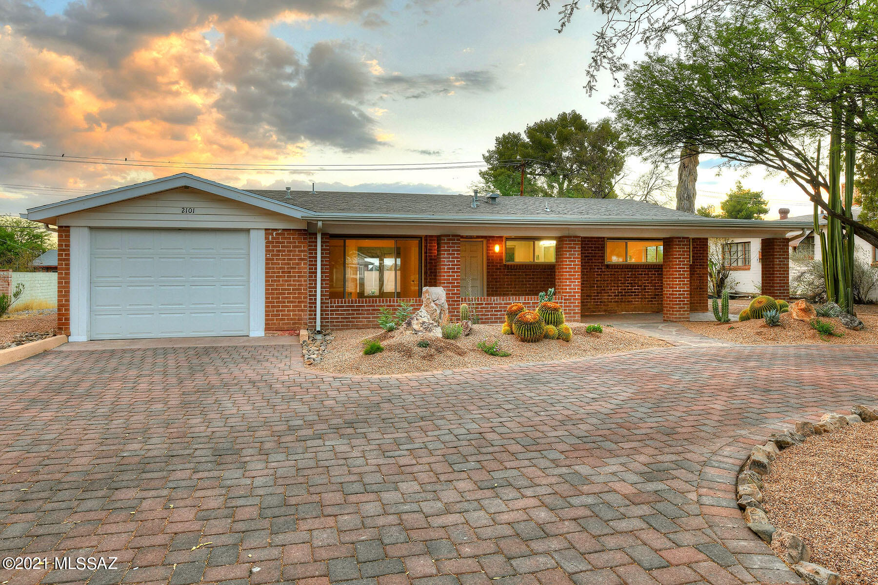 Seller will accept or counter offers between $450,000 and $475,000. This lovingly restored 1951 wire-cut red brick home is conveniently located near the U of A, Banner Hospital, restaurants and shopping. The 1,543 sq. ft. ranch-style residence includes 3 bedrooms (the living room with a full bath could be 3rd bedroom), 2 bathrooms, and a 1-car garage/workshop. The home has been extensively remodeled or updated including a new paver driveway, a new roof, a new AC unit, new interior gas lines, all freshly painted throughout (exterior & interior), all new exterior doors, all new windows throughout, brand new ceramic tile flooring with marble thresholds, and new water supply from mains to house. The tastefully remodeled kitchen provides Silestone countertops, all new cabinets, a new sink & faucet, and all new stainless steel appliances including a gas stove. The gracious master bedroom offers built-in closet shelves. Both bathrooms have been completely remodeled. The bath by bedroom 1 & 2 offers all new fixtures, a double vanity with granite countertop, a built-in dresser & cabinet, and a new tub. The second bath has a newly tiled shower and new vanity & sink. The laundry room features a washer & dryer and a new cabinet with Silestone counter. Additional features include Rolling shutters throughout, a 1-car garage/workshop with ample storage including cabinets & counters, and an expansive covered front porch. Enjoy the spacious back patio with a large roof-top observation deck and so much more. See to appreciate!