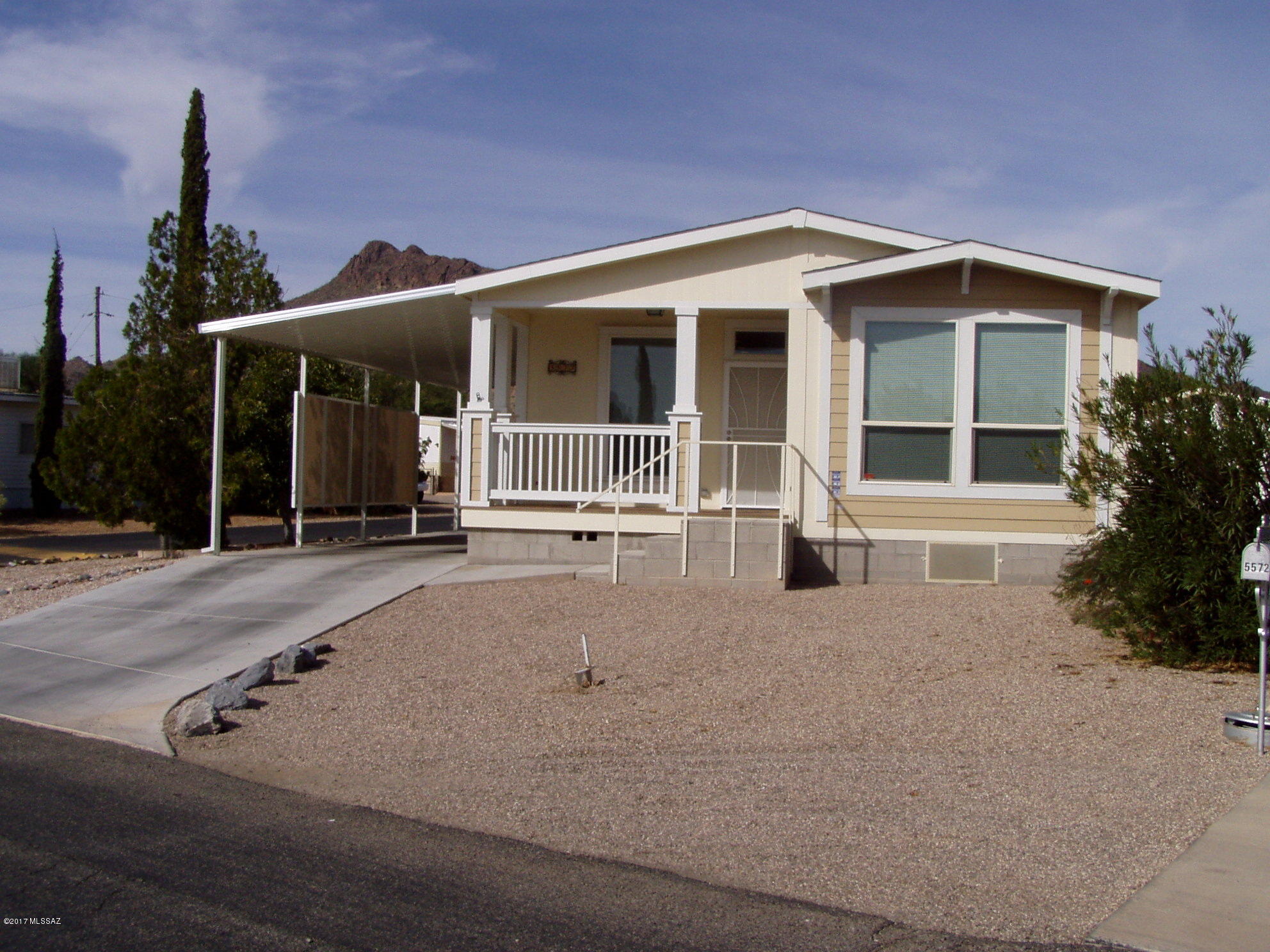 2015 2 bedroom 2 bath tape & textured home in perfect condition.  Large kitchen with island and lots of counter area and cabinets.  All newer appliances. Higher ceilings through out--3 solar tubes. Large step in shower in master bath. Tankless hot water heater. Oversized dual pane windows and additional overhead windows in kitchen, baths and walk in closets for more natural light. 200 AMP electrical service. 12' X 38' carport, 8' X 13' front porch and 10' X 12' storage building.  Paved circular driveway on corner lot. Check out the many amenities including 18 hole golf course.  You own the land.