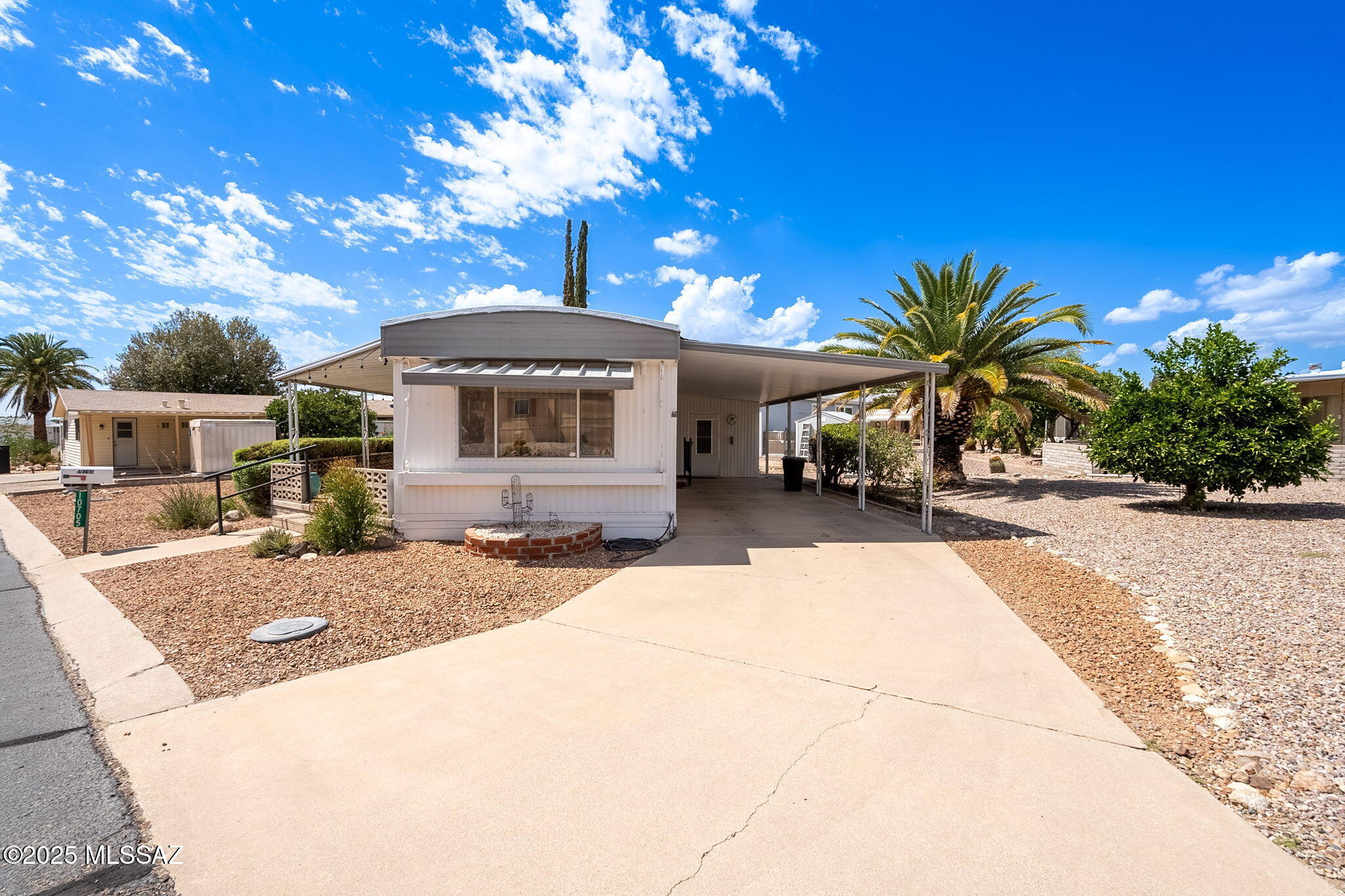 This 2 bedroom, 1 bath home has a bright, open feel with lots of natural light. The kitchen offers plenty of cabinet space, a gas cooktop, and built-in oven, with the dining area right alongside. The living room is spacious and comfortable, and both bedrooms have built-in storage. The bathroom includes a tiled walk-in shower with grab bars for convenience.

Outside you'll find a large covered carport, low-maintenance desert landscaping, and a quiet space to enjoy the outdoors without a lot of upkeep.

The Mont Blanc neighborhood is tucked into Oro Valley with great mountain views, wide streets, and a quiet setting that's still close to shopping, dining, golf, and medical services. It's a desirable area for those who want a peaceful community without giving up easy access to town.