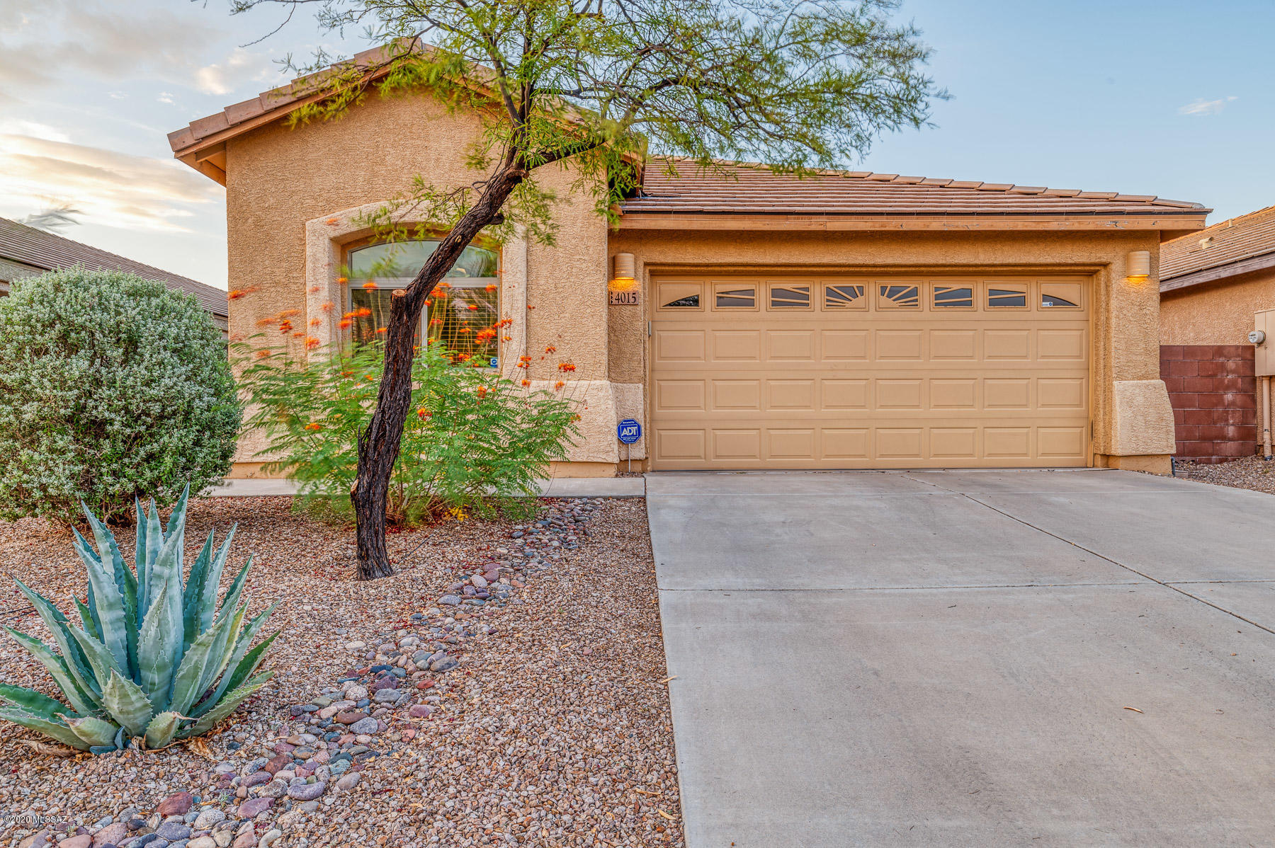 Ready to move in 3bd/2ba 1601 sqft home in Valencia Reserve! Bright, open floor plan with huge kitchen island/breakfast bar, large walk-in pantry, merillat cabinets, and beautiful corain counter tops. Great room has wired in ceiling surround sound speakers, and tons of technology upgrades including  ethernet throughout home, data panel in walk in closet, exterior HD antenna, garage door keypad, Chamberlain MyQ ready garage door operator. Huge master bedroom with walk-in closet, double sinks and garden tub in the bathroom. Nice size backyard with covered patio, 2 beautiful china berry trees, agave and upgraded rock. Premium lot on higher elevation for added privacy. Great location with easy access to I-10, Davis Monthan and TIA.