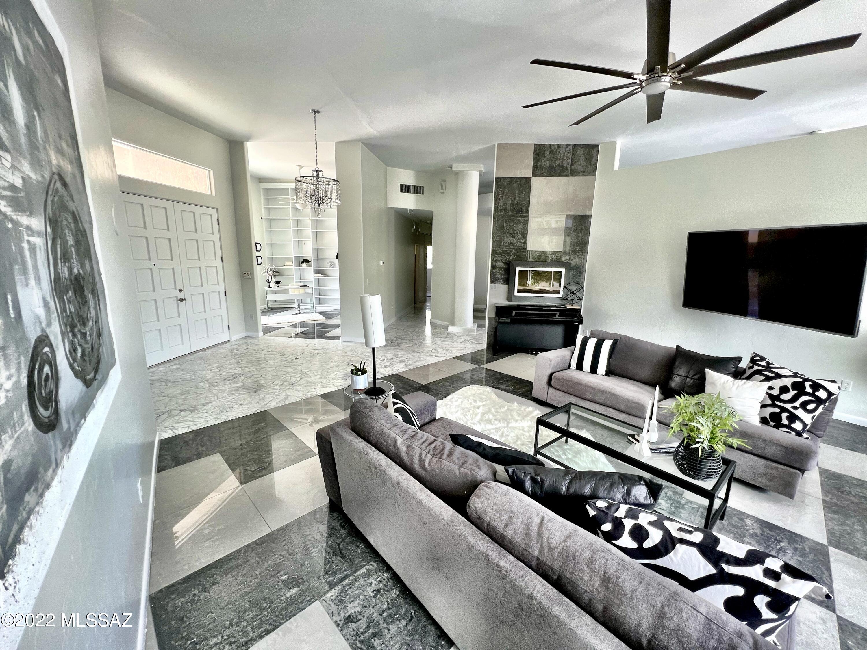 NEW STAINLESS STEEL APPLIANCES  Stunning modern home in peaceful and private corner cul-de-sac on over 1 acre with fantastic view of the mountains. Fabulous curb appeal with extensive manicured desert landscape oasis and entire perimeter of property surrounded by oleanders, front courtyard, 2-car garage and extended driveway. Impressive interior boasts 14ft-high ceilings, carerra marble and art deco tile, custom bathrooms with floor to ceiling tile and water fall shower heads, decorative ceiling fans, luxurious light fixtures, a sizeable library w/built-in bookshelves, and large open 2 living room spaces. Open chef's kitchen showcases a plethora of white shaker cabinets, custom granite counters, mosaic tile backsplash, large pantry, breakfast nook, island w/a breakfast bar, separate formal dining, & French doors to backyard. Grand main suite has backyard access, extensive walk-in closet, ensuite w/a walk-in glass shower, and dual above-counter deco sinks. The 3 guest bedrooms are located on other side of house for privacy. Backyard landscape oasis connects to Oro Valley bike/walking path.Significant home upgrades totaling almost $200,000 since last home sale.  Owner is willing to carry with a strong offer.
