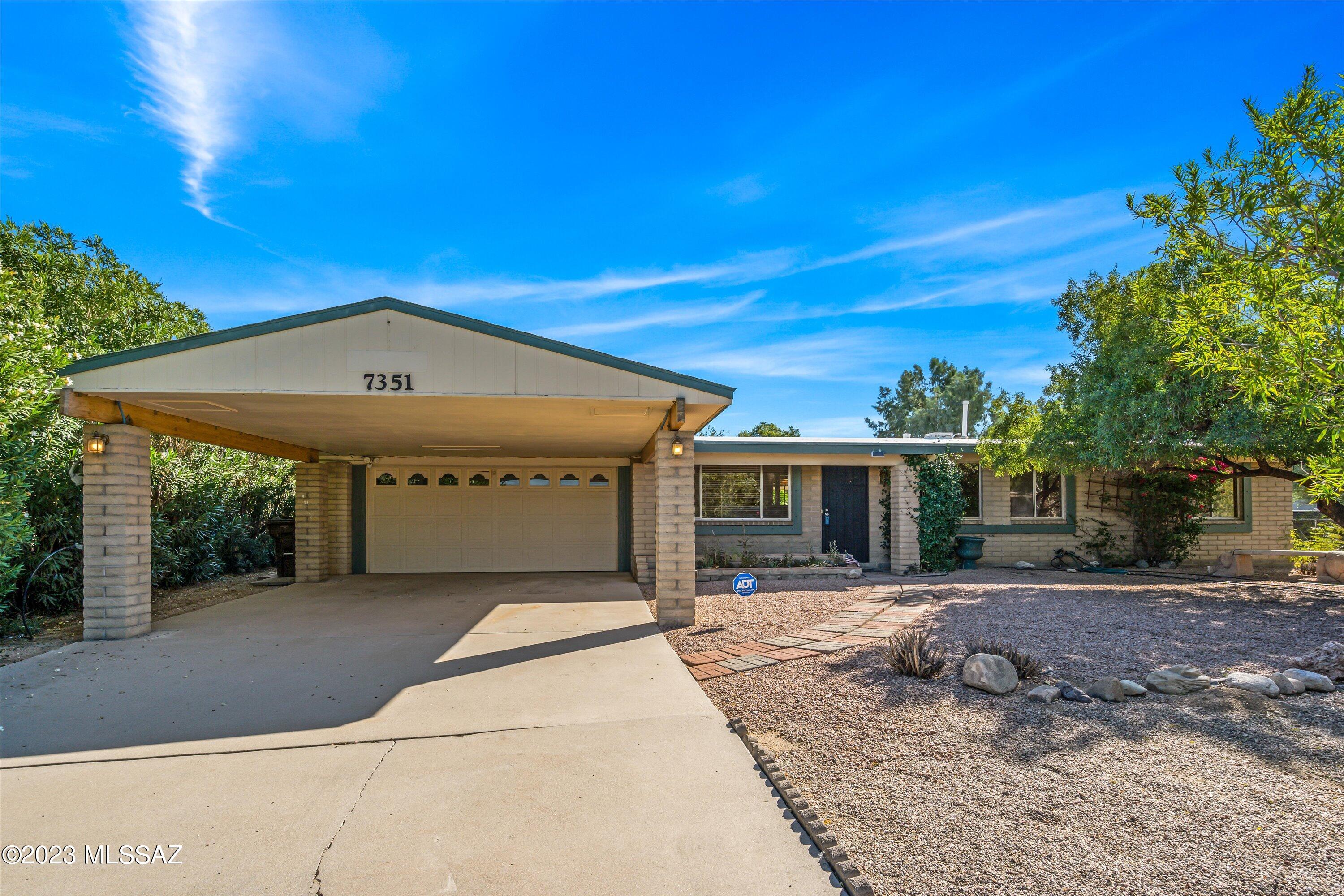 Discover a Tucson oasis with a captivating presence as this home graces an expansive lot twice the size of most in the neighborhood. This 3-bedroom, 2-bath residence offers a two-car garage and a convenient 2-car carport. A long gated driveway sets the stage, ensuring privacy as you approach the house, providing a lush front yard with mature shrubs, citrus and palm trees, and a shaded sitting area for relaxation.

Inside, a well-designed floor plan maximizes space, creating a harmonious flow throughout the home, which includes new carpet, refurbished Mexican tile, fresh paint, and new hardware and outlet covers. The backyard features grass and desert landscaping, including a dog run and a shed for storage or a workshop. The covered patio is perfect for grilling, entertaining, or enjoy or enjoying the cool Fall days.

This home is just minutes away from shopping, dining, and entertainment, ensuring convenience in your everyday life. Hiking, golf, biking, and running trails are just a short distance away for recreational pleasure.