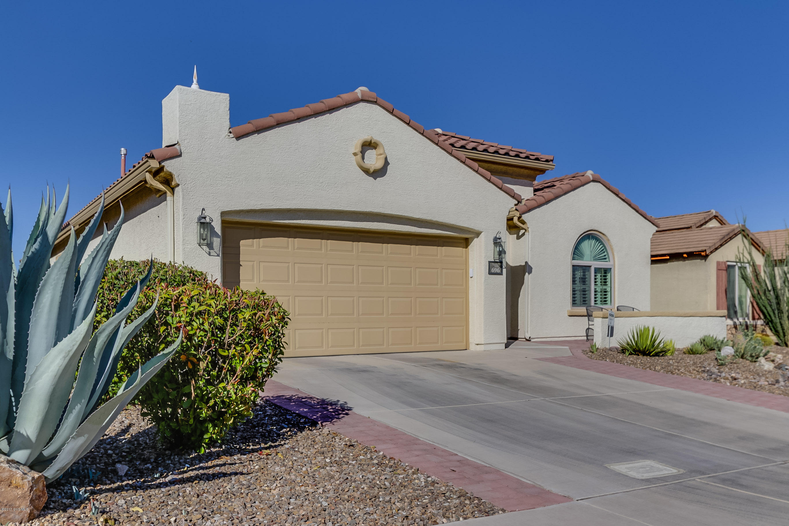 This incredible Arivaca Model does not come on the market often,this beauty boasts 2082 sq ft, 2BD/2BA plus Den, Curb appeal + take the walk up to see a nice cozy sitting area in the front, walk through this custom security door and enter into a generous foyer that will open up to a spacious Living/Dining area. Custom plantations throughout. The Kitchen has a large eating nook for looking out the window at the hummingbirds while you enjoy breakfast. Ample stacked cabinets and counter space plus center island. A Convenient pass through opening for easy entertaining. All appliances stay, even the W&D! The Master Suite is enormous, will fit any size furniture! Master bath has dual sinks, exec hgt counters and a walk in closet. The split bedroom plan will allow guests privacy and the Den  i perfect for an office, library or another bedroom. Out Back, you will enjoy the oversized flagstone patio to have friends over for a relaxing evening while enjoying the quiet of the Sonoran Desert. Come see this immaculately maintained home and see why this Active 55+ Community is ideal for year round living or even part-time.