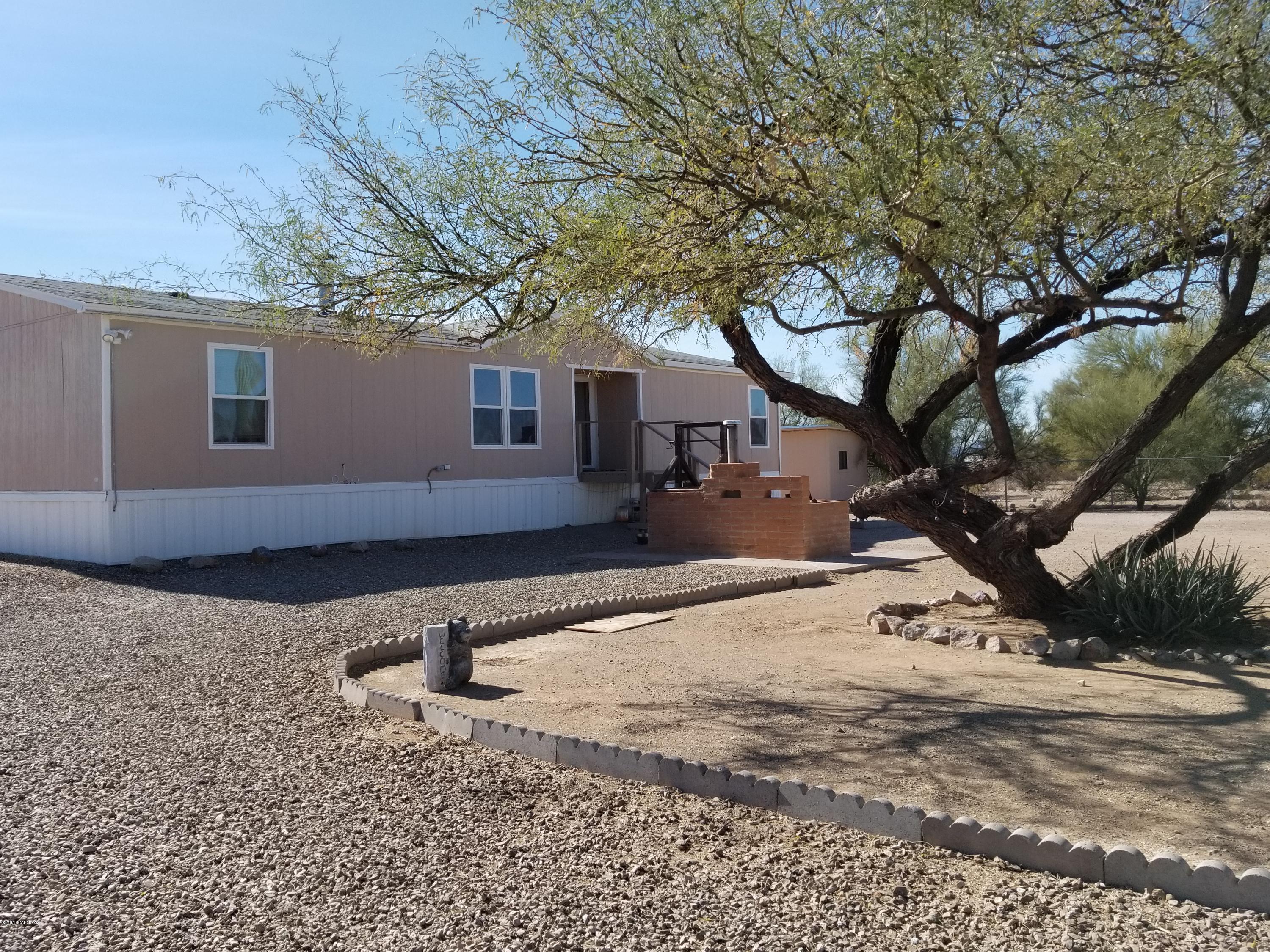Manufactured Home on One Fully Fenced Acre. Split floor plan w/ 3bd/2ba Flowing Open Floor Plan.  Kitchen includes bbar, DW, micro, fridge & pantry. Dinning off kitchen. Living room has beautiful stone fireplace, North facing windows give wonderful mountain views. Spacious master w/ walk-in closet, garden tub, sep shower, & dual sinks. Laundry room off kitchen offers storage and access to backyard w/ large wooden storage shed & built-in BBQ. Low maintenance landscape w/  Several Saguaro Cacti! 
This property is move-in ready. Come enjoy spectacular sunsets, night sky's and spectacular mt. views! Easy access to 1-19.  For MFH financing call: Thomas Hathaway 520-331-0943