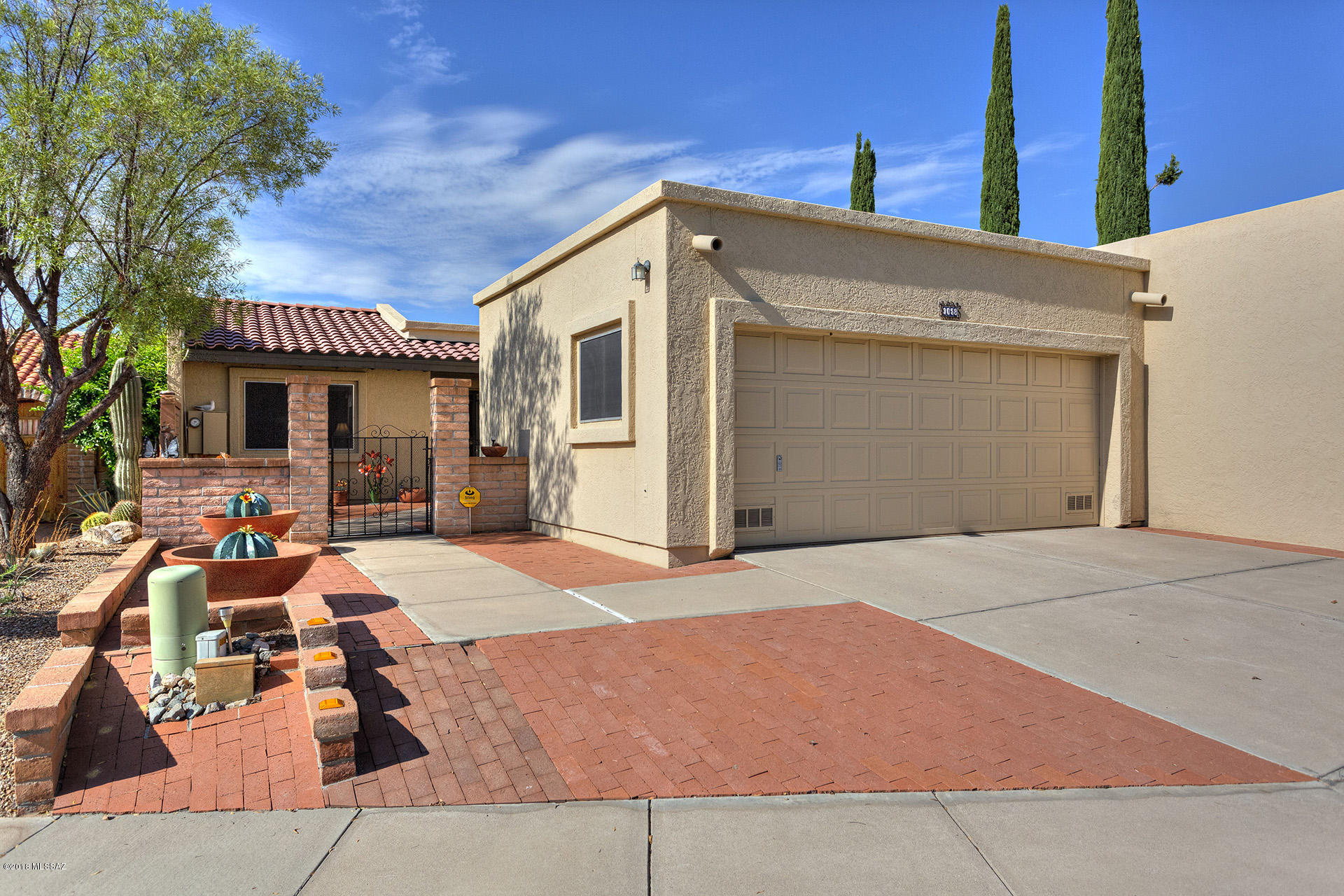 Super home in Desert Hills 4,2 bedrm-split, 2 bath, 2 car garage(over size, storage cabs and epoxy floor), super large kitchen w/a huge island, open living room and Beehive fireplace, den and a sitting room. Good size master bedroom, fans,loads of skylights, a lovely entry courtyard and a super private backyard...both are easy care (no drip system)! Back opens to a large common area.  Wood front door, paneled inside doors, sunscreens just lots of great finishes. This home is Clean and Maintained. NEW HEATING/COOLING UNIT 2016!!!