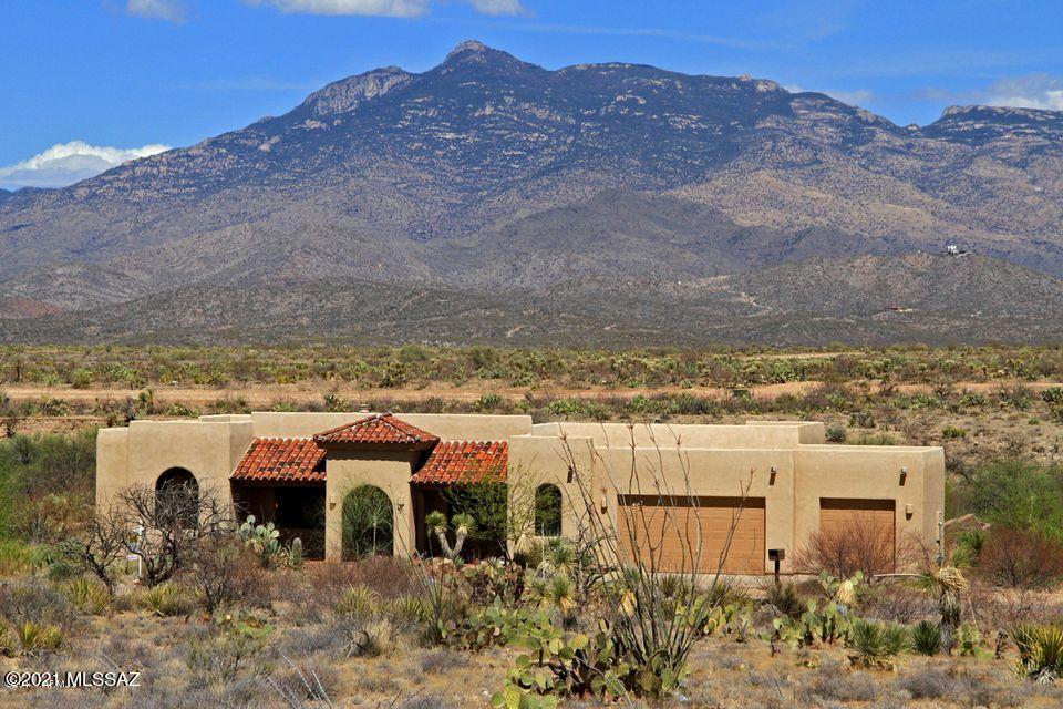 Fantastic Custom built home on 1.21 acres in the shadow of Rincon Peak!  Here, the mountain VIEWS, skyscapes and desert vistas inspire.  This split 4 Bedroom/2 Bath Willoughby built home has wonderfully open & inviting gathering spaces.   Solid, natural colored Knotty Alder doors and cabinets throughout add elegant charm as do the custom designed wood window coverings. Mountain VIEWS captivate in every direction.  Passive solar keeps it cool with extensive front and rear covered patios and mature vegetation. The Kitchen opens to the Great Room w/fireplace and mesmerizing VIEWS of the Rincon Mtns.  To the rear of this parcel, is a wildlife corridor offering your very own Desert Museum.  Over 70 bird species have been sighted in this rear yard.  In acclaimed Vail School District, the bus picks up students here at Windmill Ridge.  Just off I-10, you can enjoy desert rural living and get to most services within 15 minutes.  Come enjoy time out and a deep breath at this home offering the best of both worlds.  Windmill Ridge...Mountains to live by!