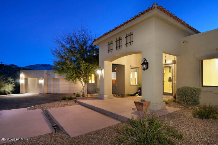 Located in an often over-looked part of the Foothills, up a quiet street, and through a security gate, this Mediterranean-inspired custom home has many architectural touches and sits on a large 1.6 acre private lot in a neighborhood of less than 40 homes. This home features: travertine tile floors throughout; granite counters; high ceilings and an open floor plan; large Master suite with luxurious bath, spa tub and access to patio; mountain views from family room; east-facing back yard with fountain enjoys afternoon shade from the patio;central vac; rolling security/shade shutters; RO & soft water systems; art lighting; and the third bay of the garage has been partitioned with HVAC for an additional 358 SF not included in MLS total.