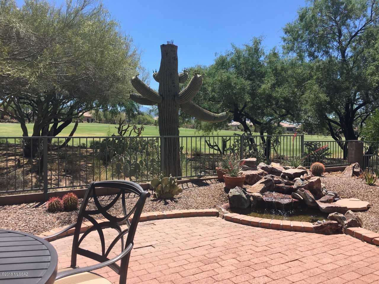 FELL OUT OF ESCROW. Stunning golf course and mountain views !  No cart path and very private backyard with waterfall. This Aurora has been redesigned to create an office and open greatroom floorplan.  New tile throughout except for new carpet in bedrooms.  Kitchen island has been dropped and new granite installed. including new sink and ''touch'' faucet.  Stainless steel appliances, toto toilets, fairly new AC and furnace.  Master shower has been redone with glass shower door.  Relaxing gated front entrance courtyard. Electronic sunshades on east side of home. Laundry room. 2 car garage. New water heater. Sparkling clean and ready to go !