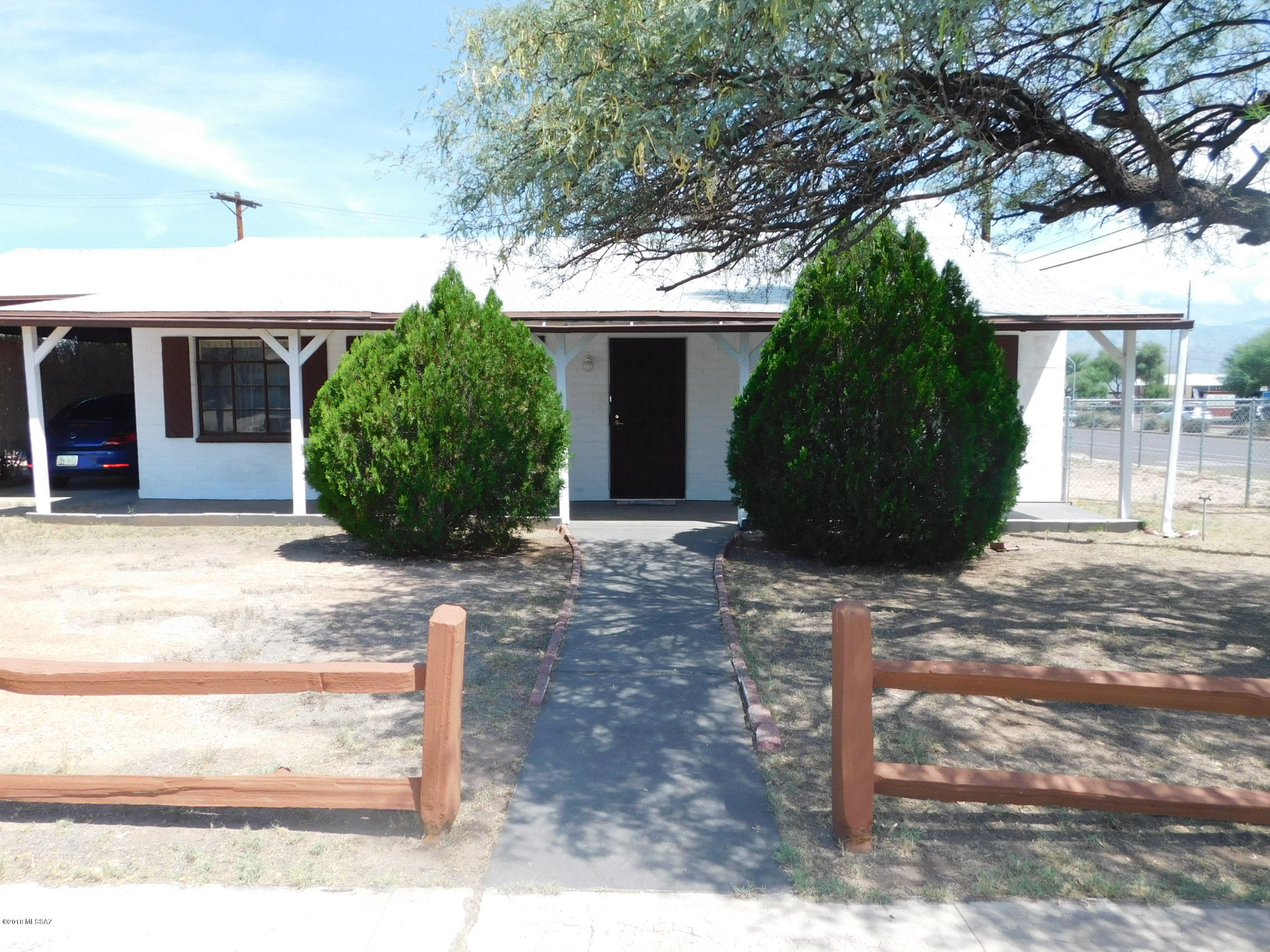 This charming home is on a corner lot, and has a beautiful front porch that spans the entire length of the house. When you walk in the front door you are greeted with a warm and inviting living room and dining room. The kitchen sports tile counter tops and is attached to a huge room that can be used for a pantry or additional storage. The three bedrooms are very spacious. This home has original doors which are very attractive. The backyard is huge! Great location close to shopping, restaurants, and entertainment.
