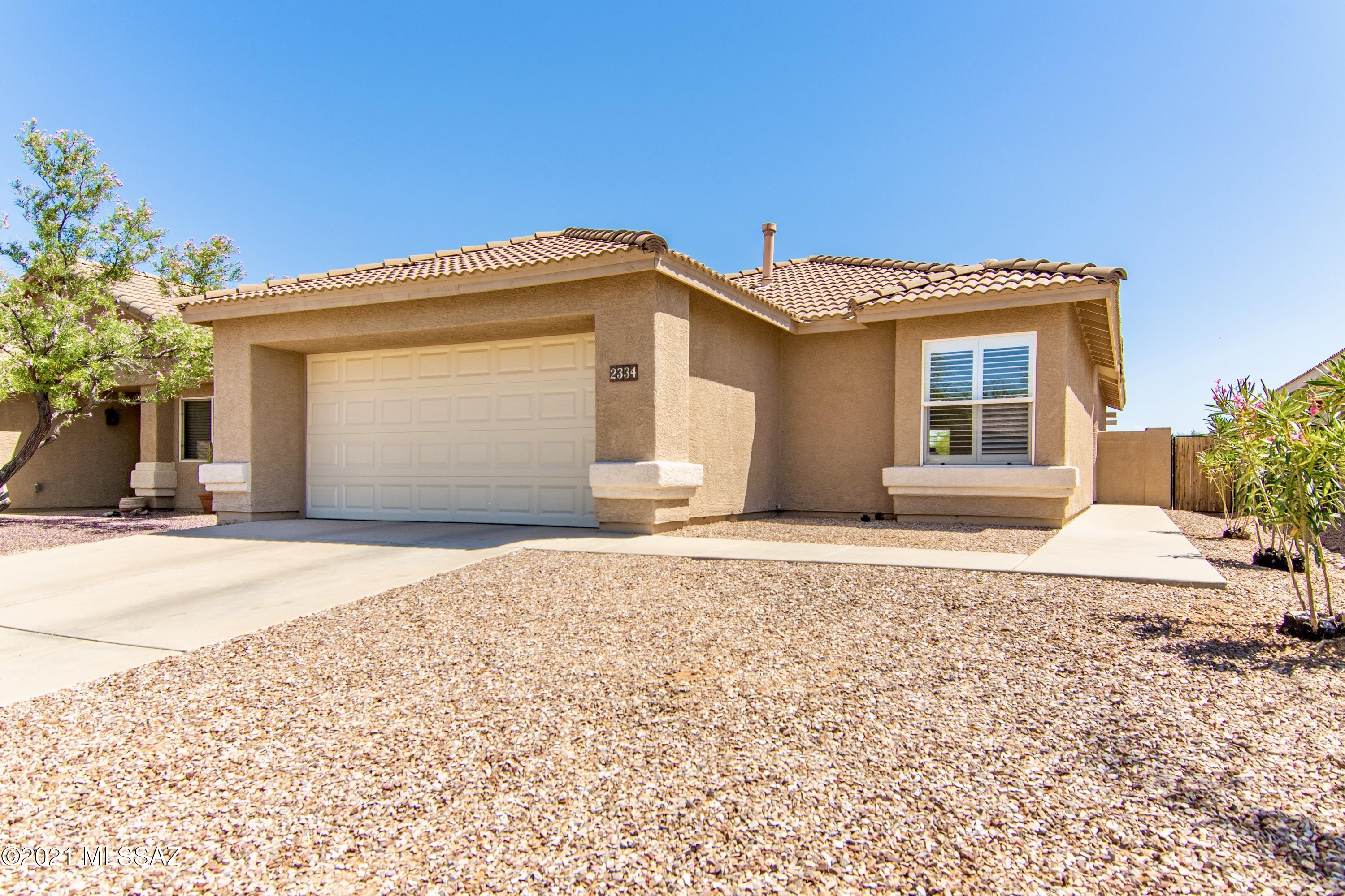 What a gem! Immaculate condition with updated finishes, views of the Catalina Mountains, and Pusch Ridge. Bright, open floor plan with a great room concept, vaulted ceilings, engineered wood floors throughout, new upgraded baseboards, heat-repelling plantation shutters, and fresh paint. The kitchen offers solid slab granite counters with a breakfast bar open to the dining area, stainless steel appliances including a convection oven, and a beverage/wine cooler. Large master suite with private bath, walk-in closet, and bonus room for a den or office space. Ample storage including a dedicated kitchen pantry, deep laundry closet with shelving, and free-standing garage cabinets. Lovely outdoor living space with a large, partially covered brick paver patio, 6' privacy walls, and gorgeous views!