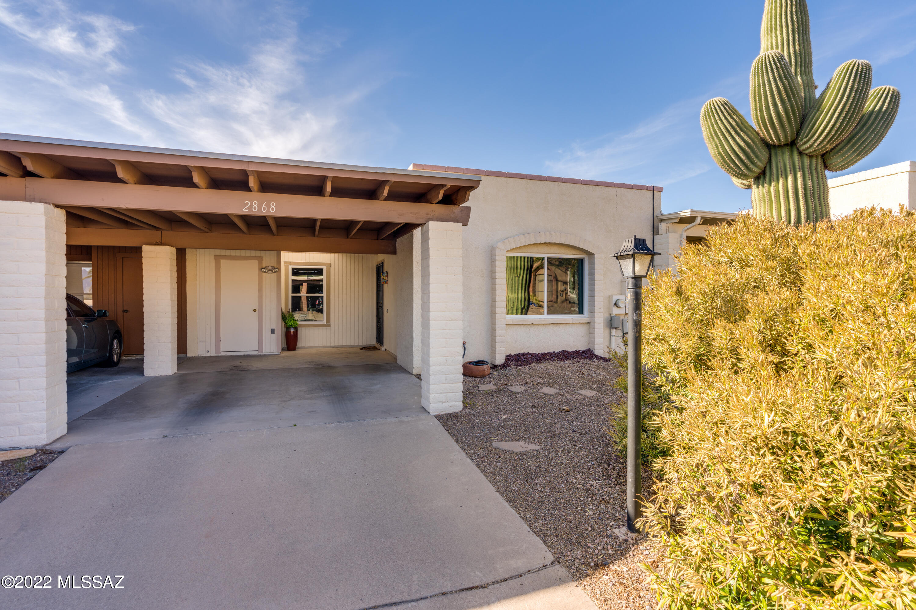 A majestic Saguaro welcomes you to this move-in ready, 2 BR 2 BA townhome in Desert Hills II. Updated tile plank floors in the living and dining areas. All new windows in the bedrooms and front room. New plantation shutters. Remodeled main bath has new vanity and tile shower. New carpet in both bedrooms. Kitchen with large pantry closet. Enclosed Arizona room off laundry and main bedroom ideal for office or hobby area. Low care backyard with paver patio backs to common area, and a peek-a-boo mountain view from the front window. Close to Desert Hills GVR Center.