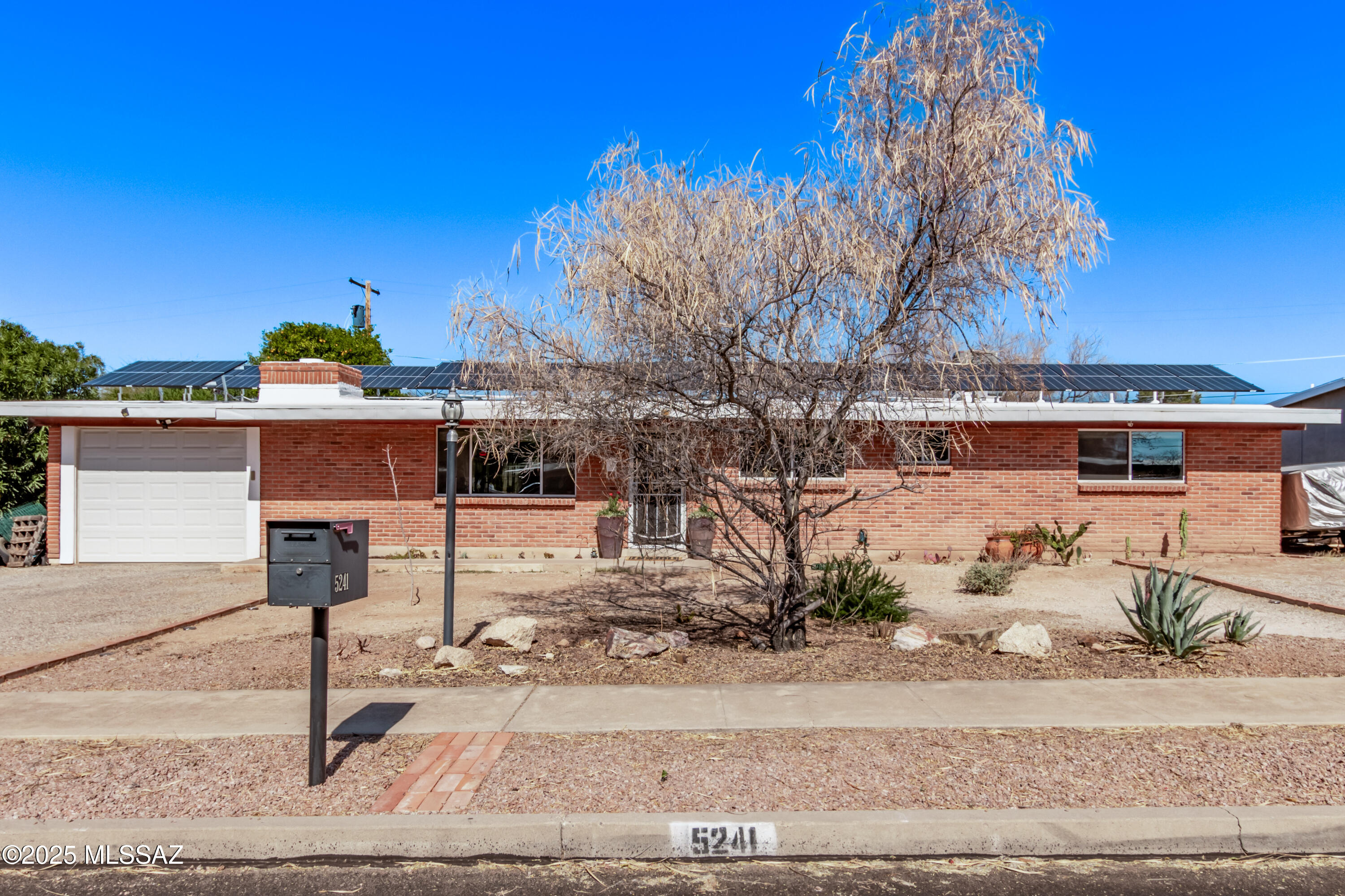 Discover this charming 4-bedroom, 2-bath home in a fantastic location near shopping, restaurants, and not far from the University of Arizona! This beautifully maintained home features a remodeled kitchen, brand-new carpet, and a brand new roof, along with a newer AC and furnace for year-round comfort. The inviting backyard is perfect for entertaining, complete with a unique chicken coop and a stunning custom gate painted by renowned local artist Danny Martin. Additional features include a rooftop solar system and an electric vehicle charging station. Don't miss this incredible opportunity to own a quaint home in a prime location with no HOA!