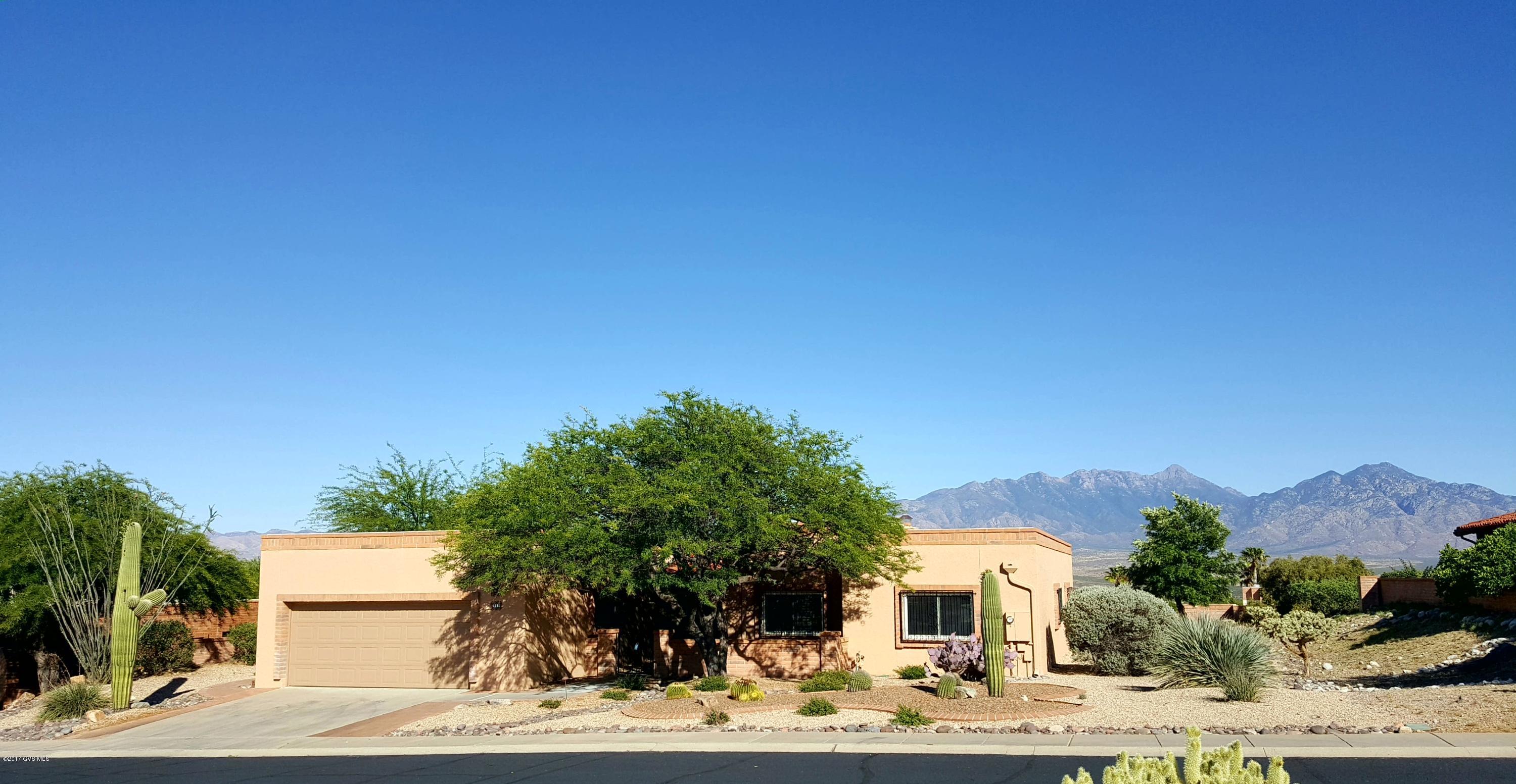 A former model home with original owner. This free standing block home is located high on a hill with exceptional panoramic mountain views of the Santa Rita mountains. A great location on a truly spacious lot of almost a 1/2 acre with plenty of room for a pool. Features SS appliances ,gas stove, gas beehive fireplace and a wet bar for entertaining. Beautiful water feature, front and back re landscaped , with irrigation replaced and pavers added on the rear patio. The exterior was painted approx 2 yrs ago, all windows and sliding glass doors have been replaced and are triple pane. Commercial grade Membrane roof installed with 2'' foam insulation warranty thru 2021.New drip system front and back 2016,Exterior house painted and bricks sealed 2013,New water htr 2013. HVAC replaced in 2000