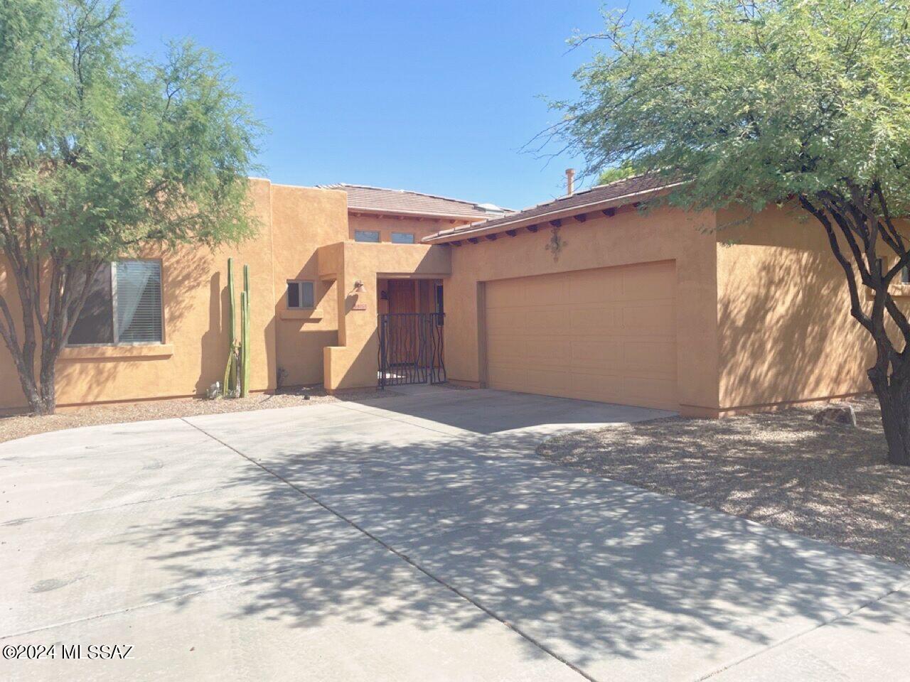 No Application Fees!  Very nice 3 bedroom, 2 bathroom single level Tucson home located in Continental Reserve.  This open floor plan home has wood laminate flooring in all living and high traffic areas with carpeting in each bedroom, two tone neutral paint, large open living room with stone fireplace and great natural light.  Updated kitchen features granite countertops, subway tile backsplash, upgraded cabinets, breakfast bar and all stainless-steel appliances.  Washing machine and dryer are included.  Enjoy the professionally landscaped backyard with nice covered patio, extended paver patio, synthetic grass area and easy to maintain plants and trees. All Denali Real Estate residents are automatically enrolled in the Resident Benefits Package (RBP) for $55.00/month which includes Renter's Liability Insurance, Credit Building to help boost the resident's credit scores with timely rent payments, up to $1M Identity Theft Protection, HVAC air filter delivery (for applicable properties), our best-in-class resident rewards program, and much more!