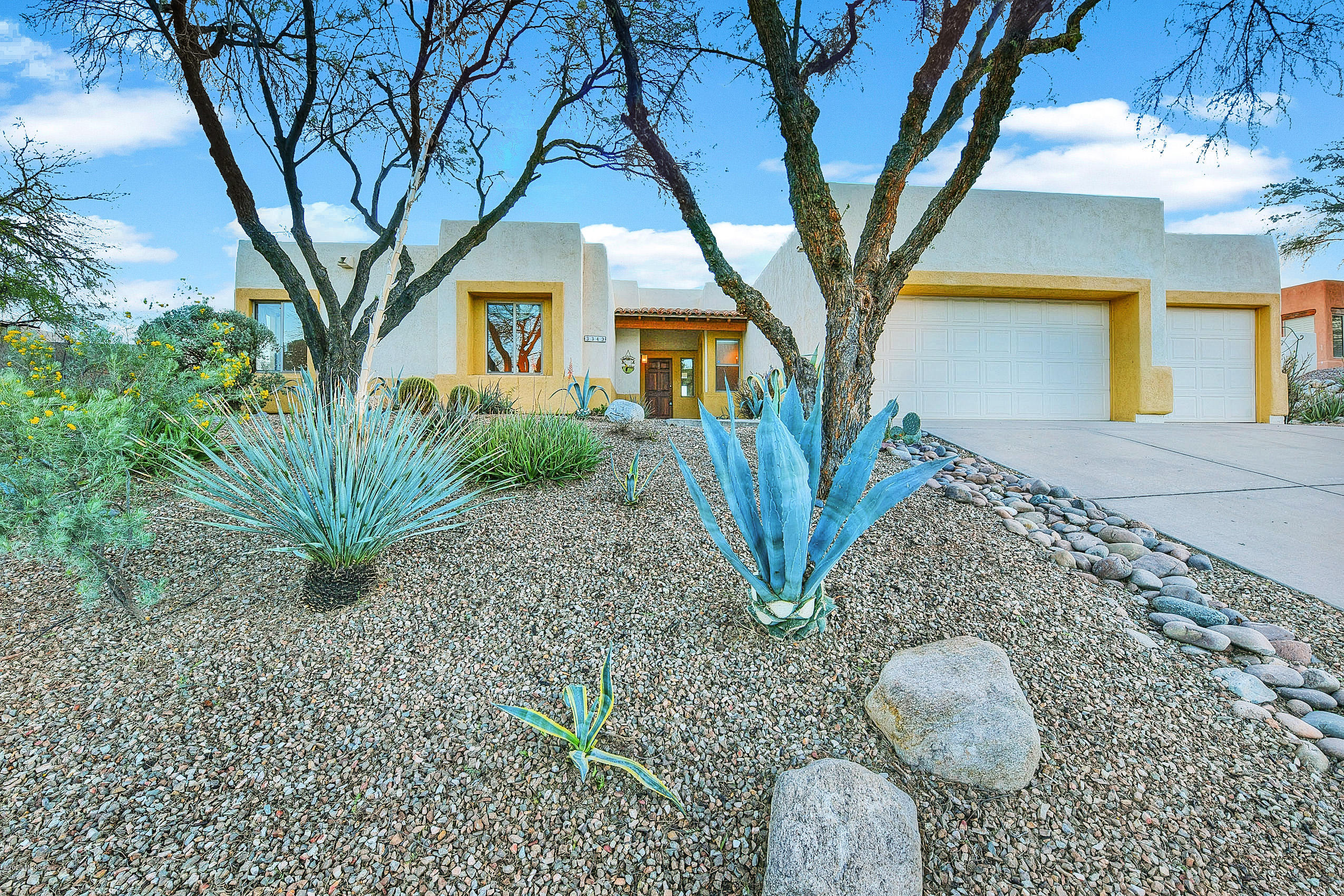 You don't want to miss out on this beautiful Santa Fe stunner. Nestled in the exclusive Starr Pass resort community, you'll enjoy access to UArizona, Banner Medical and all the best shopping and dining. With beautiful views and plenty of walking trails, this home is perfect for active adults, families or even as an ideal second home! This professionally landscaped home is oozing curb appeal with lush and natural desert greenery greeting you outside. 
Inside, gorgeous architecture and high end finishes are highlighted by designer flooring and natural light. The open-concept great room and kitchen provide plenty of room for entertainment and boast easy access to the covered patio and beautiful golf course views. Don't let this one pass you by - schedule your private showing today!