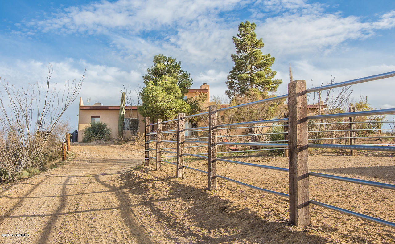 Call about a discount for city/state/Fed employees. Fantastic Horse Property; This 3 bedroom 2 bath Southwestern home in pristine southern Arizona has outstanding horse facilities and huge circular 58’ arena made from rail road ties, a double covered stall, a single covered stall and an attached paddock.  The attached shed/tack room has a pass through feed barn.  Trails and washes are abundant for horseback riding, mountain biking, hiking, atv riding, etc. Perfect location for stargazing with no city lights and nature/bird watching; avg 5-10 degrees cooler than Tucson.  Retreat into the Great room with fireplace, Living Room, Formal Dining Room plus an office/nursery off of Master Bedroom.