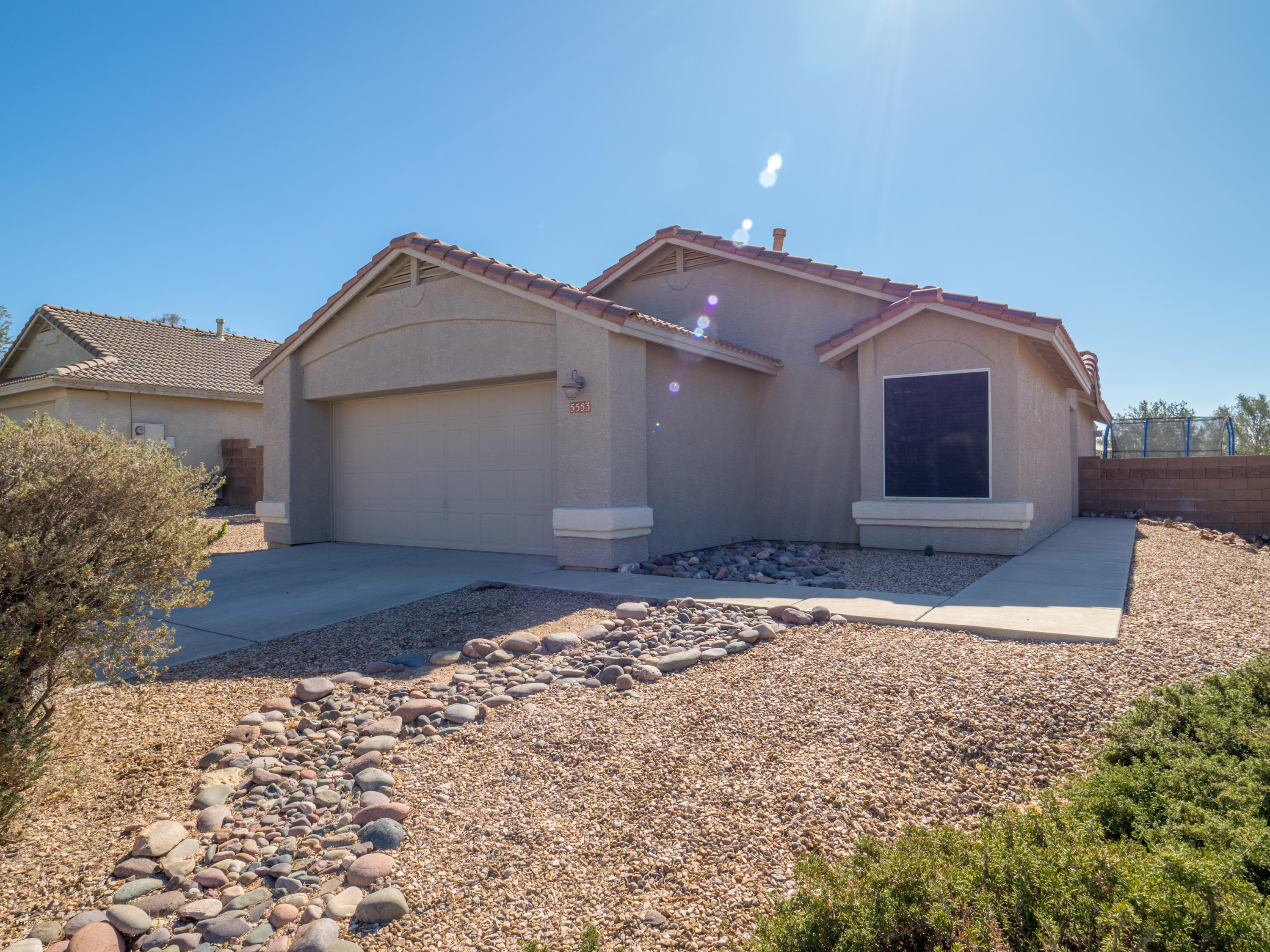 Sitting in the Tortolita foothills on Dove Mountain lies this 3 bed 2 bath single level home. Easy access to 1-10, near golf, dining, shopping, parks, hiking, and cycling. Charming Quail Crossing home with fantastic backyard. Laminate floors and tile, no carpet; ceiling fans, vaulted ceilings; gas range. Spacious family room with direct access to covered patio, gas fire pit, raised deck, sunset views. Master has walk-in closet and double vanities.