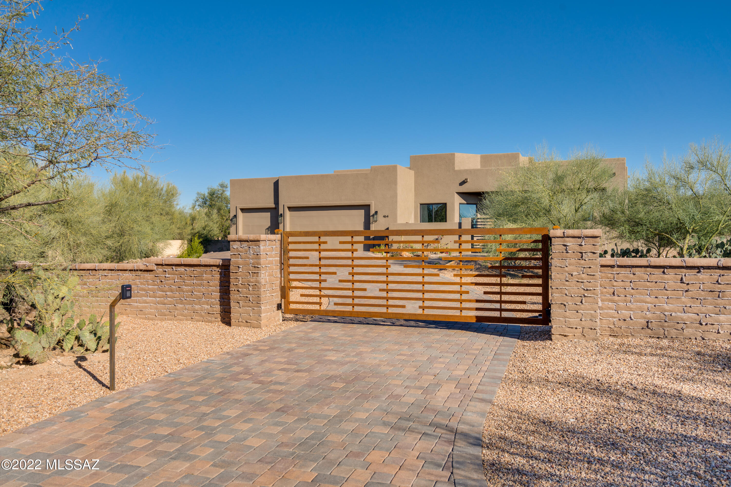 Stunning new custom home in the heart of Tucson in the Indian House community. Privately gated on over a ½ acre lot.Custom gate entry at courtyard opens to custom wired brushed door into the gorgeous great room. Light pours in w/ soaring ceilings showing off the gorgeous appointments & custom features. Expansive chef's kitchen w/ massive island & eye-catching quartzite tops, pantry, 12'' custom hardware, SS appliances and a textured tiled backsplash. Baths boast unique Quartzite & Quartz, designer tile, custom vanity & hardware. Gorgeous owners ste w/ 2 lg. walk-in closets, dual vanities, inviting tub & elegant shower. Other features; oversized 3 car garage, 2 expansive covered patios, huge walled backyard.