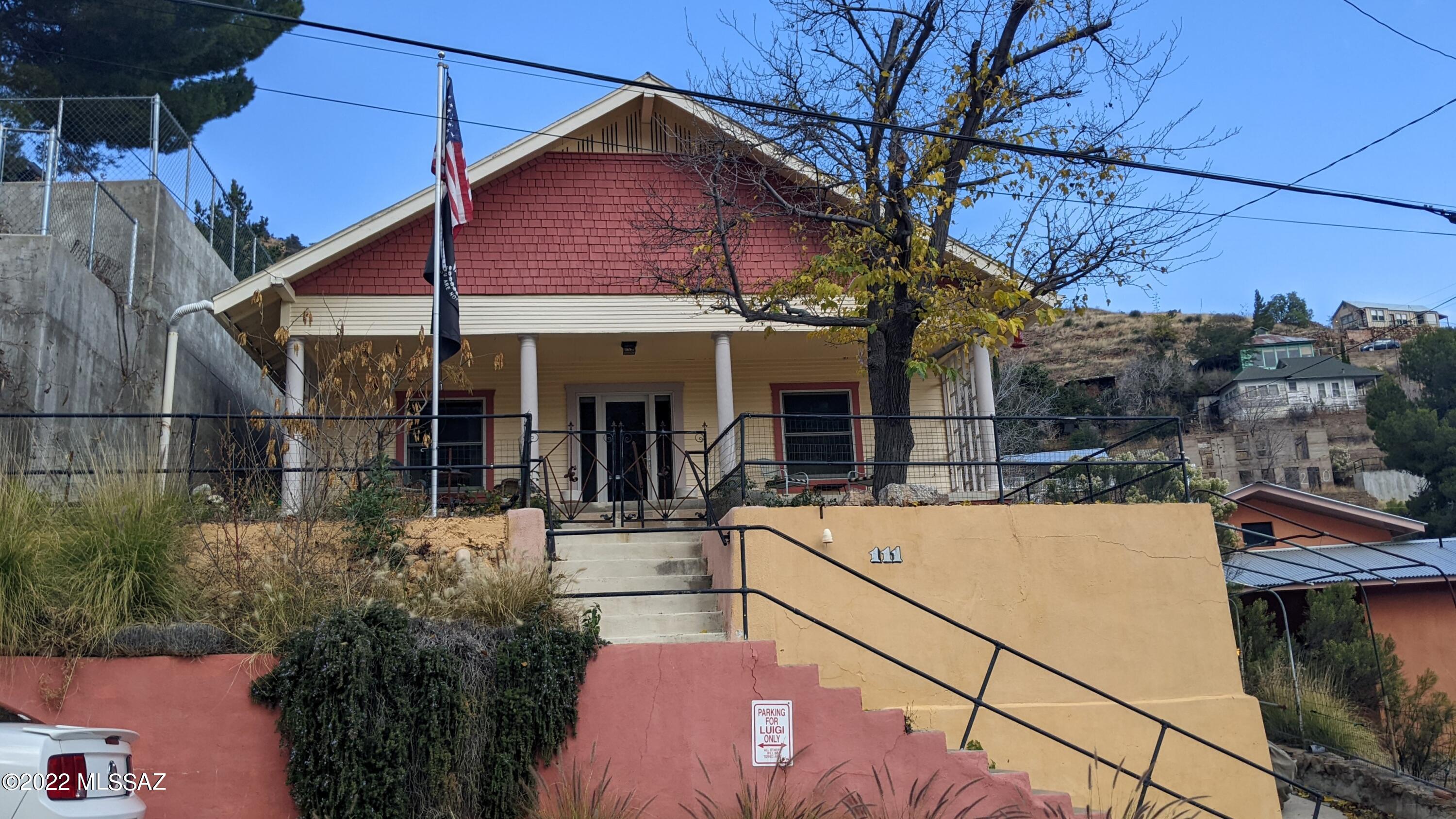 This historic minors bungalow has all the charm expected in an Old Bisbee home. GREAT Downtown location! There is parking on the street in front of the home, designated parking to the Right of the house and only 24 stairs to get to the front door. Outside you can enjoy the views from a spacious back yard with a Travertine patio, garden area, and Carriage House that can be used as a workshop or extra storage. Inside you will find beautiful refinished Oak Wood floors, dual pane windows, central AC and heat, tankless water heater, an updated kitchen and bathroom. There is a dining room and large living room, as well as a front room that was used as an art studio but can be converted into a 2nd Bedroom by adding doors. There is an unfinished basement with tons of storage space AND a hidden room! This room is finished, with walls, flooring, a door, and attached cabinets. YOU HAVE TO SEE THIS HOME TO FULLY APPRECIATE IT!