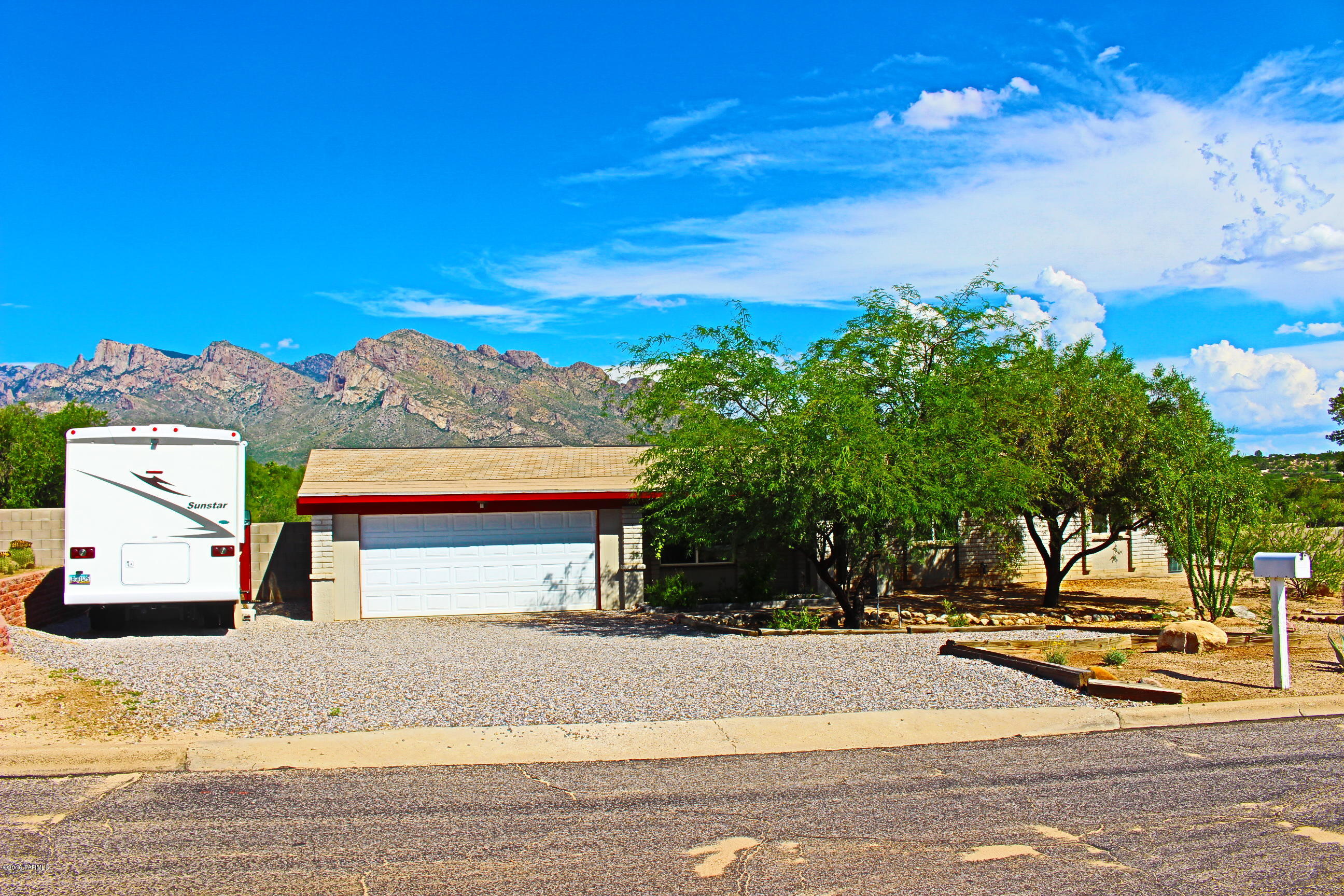 SELLER MOTIVATED! PRICED BELOW APPRAISED VALUE! Oro Valley energy efficient solar home on almost 1 acre! NO HOA! Bring your toys! 3 bed/2 bath plus bonus room for office/exercise/storage. Many Green features including Solar Electric and double paned windows. Updated kitchen and baths, cabinets and appliances, UPGRADED electric panel. Private, huge yard with beautiful mountain views and gate access, screened porch w/ views as well as open patio spaces, mature landscaping. Spacious rooms, walk-in closet in master. RV hookup, 30amp. Hot tub conveys. You will not find a lot this size at this price in Oro Valley! Amphi schools,convenient to shopping, parks and transportation.