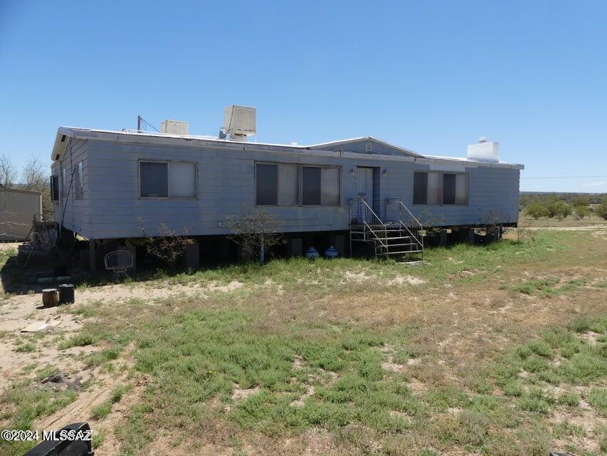 Discover a diamond in the rough with this expansive 4 Bedrooms and 4 Bathrooms triple-wide mobile home, set on a sprawling 5-acre lot in the serene surroundings. Owner may carry with $30,000 down. While in need of some TLC, this property boasts great bones and presents an incredible opportunity for those looking to infuse a space with their personal touch. As you enter, the potential is palpable. The spacious open floor plan awaits your vision to transform it into a cozy yet elegant living space, ideal for both quiet family life and vibrant gatherings. Natural light floods the interior, inviting you to imagine the possibilities that lie in reviving its charm. The kitchen, with its ample layout, stands ready in the heart of the home—a culinary haven where functionality meets style