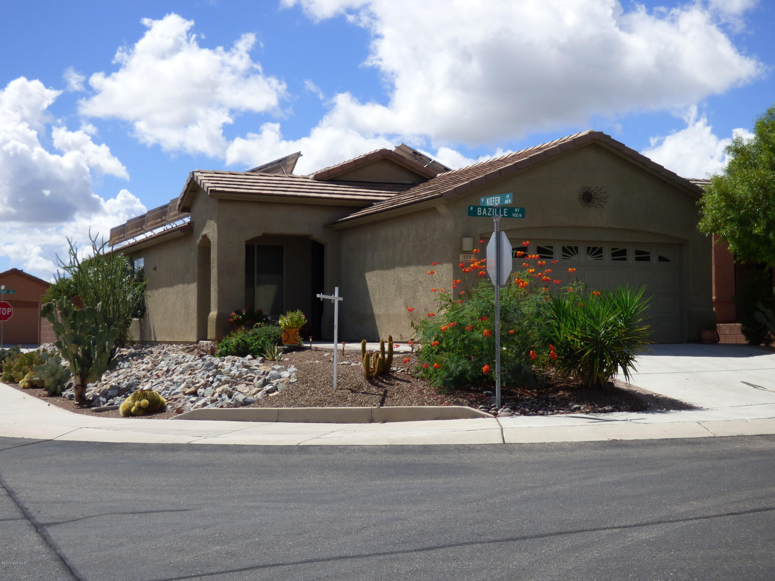 Exceptional corner location with mountain views from the great room, den and covered patio. Bright and cheerful. Beautifully tiled throughout exc. bedrooms. Kitchen features additional cabinetry fro added storage, gas stove and breakfast bar. Dining nook with front views. Rev. Osmosis for pure drinking water. Owner's suite with walk-in jetted tub/shower. Guest bedroom features wall-bed with extra book shelves and fold-down table if not used as bed. Instant hot water throughout. Den with views. Covered patio overlooks water feature and distant mountains. Sun screen and gas hook-up for your BBQ. Extended garage with storage cabinets. Solar panels (incl.in price) have reduced electricity costs to $57 a year in the past.