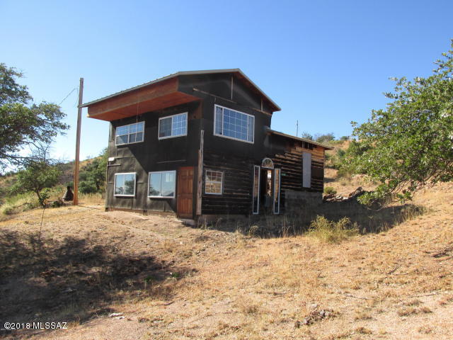 Awesome views from this Oakdale Ranches property. Water, power and septic on this property, plus the structure. Finish work on this cabin/shelter and it will be the perfect get-away. 9.9 acres with mature trees, gently sloped with mountain and valley views. A new metal roof was installed in 2008.  Bring the RV, there is plenty of room for parking! Well number 55-551651.