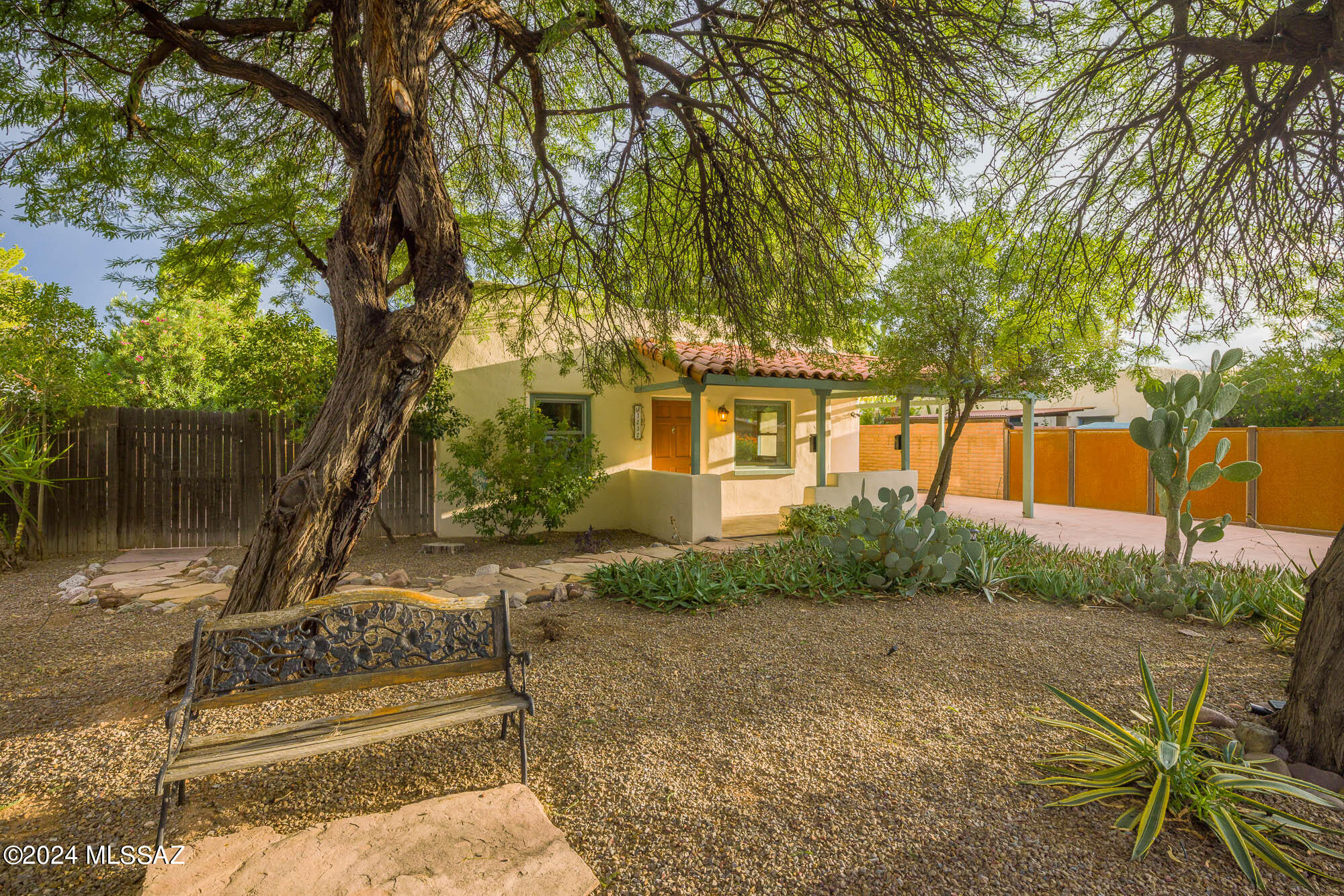 Main house built 1949. Guest house built 2005.  The curb appeal is outstanding with Old growth Mesquite welcoming you home. Front patio is oversized and open.  These charming homes, tandem perfectly together in this well established neighborhood.  Colored and scored concrete floors. Sand blasted wood beamed ceilings give this home grounding and cozy feel.  Cherrywood custom cabinets with granite counters.  In both homes and all bathrooms. Hunter Douglas window treatments on the double pane wooden windows. Spacious bedrooms with two walk in closets. Pomegranate and young Citrus tree all on irrigation system. backyard nooks within the Adobe walled backyard. Newer Roof, close to Banner and UofA. Downtown Tucson is wonderful place to enjoy Tucson year round.