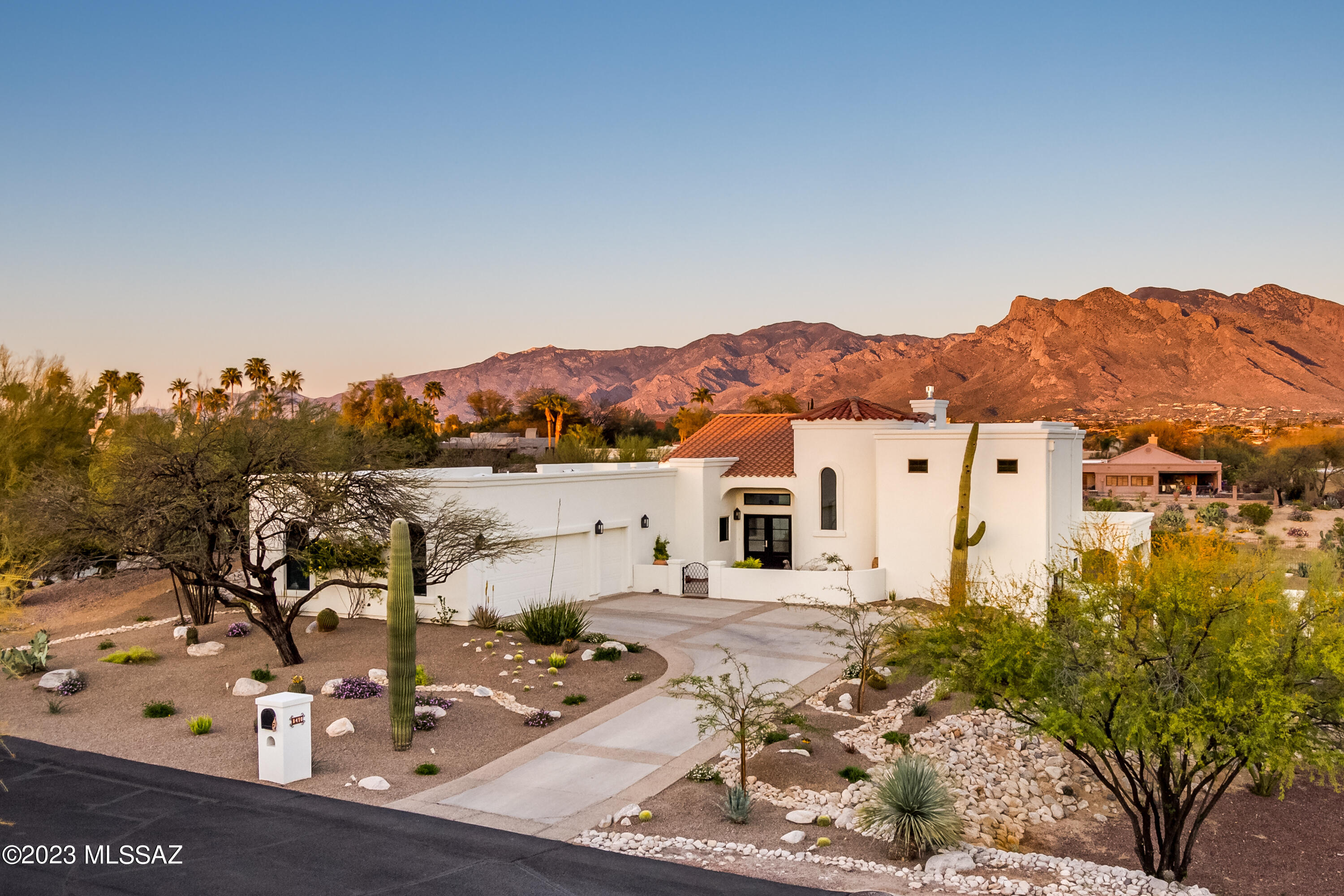 Located within gated Omni Tucson National, this home sits on the 18th fairway of the Sonoran course. Totally professionally renovated & updated in 2022. Interior Design & Vision by Michelle Carnes Design. Brendan Guthrie, General Contractor. Priceless views of the Catalina's from inside as well as from the sweeping patios across the entire east side of the home. Practice your putting on your own backyard green.  Enjoy a dip in your pool or sit by the outdoor fireplace to watch the mountains turn pink. Tuck your own golf cart in its very own garage. Huge storage room with shelving at back of the oversize garage. This home will inspire the most discerning homebuyer. Omni memberships available for enjoying all the resort amenities. See Document tab for incredible amenities