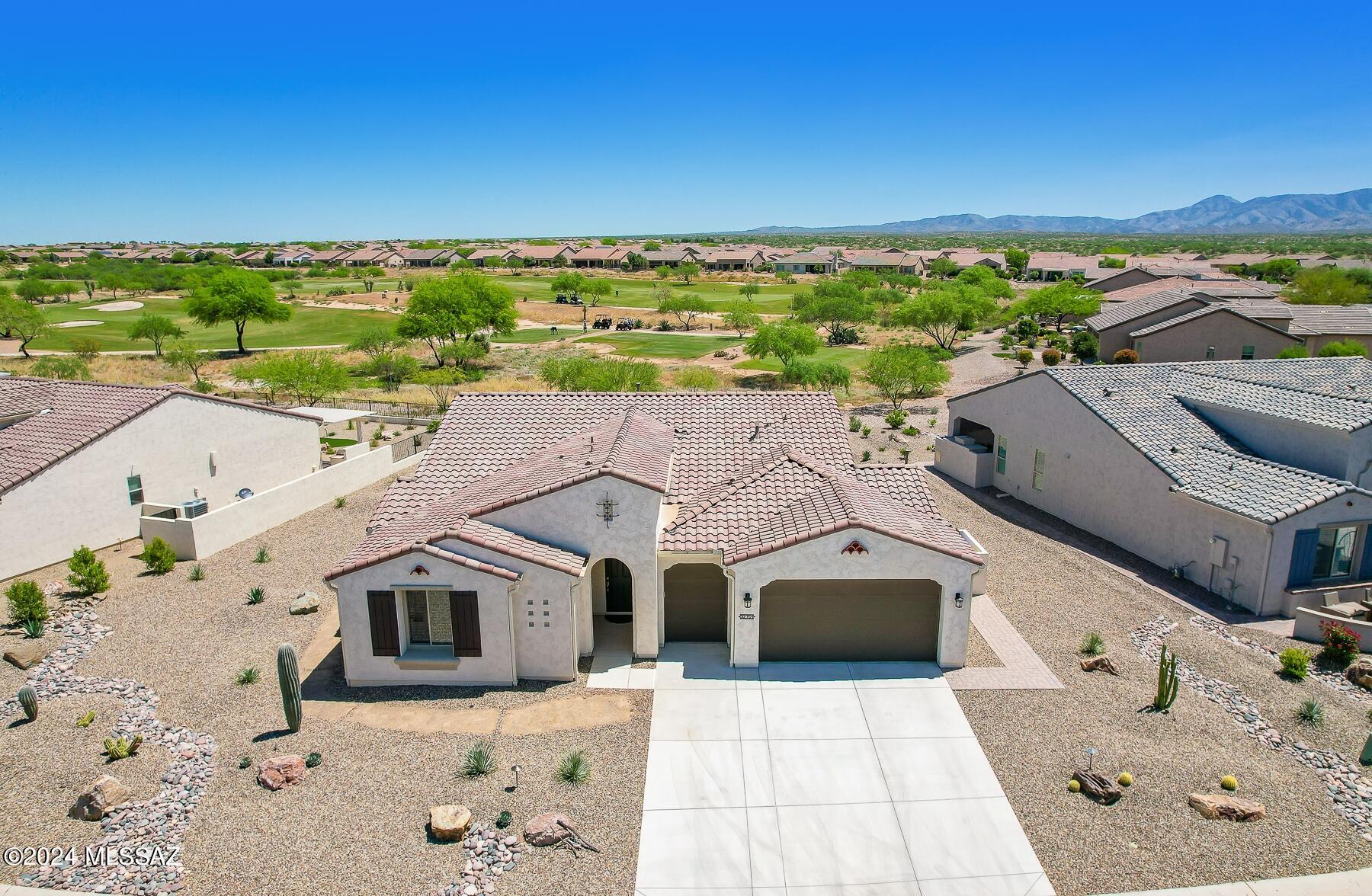 Striking newer 2BD/2.5BA +Den (2,183 sq ft) private home off golf course boasts mountain views. Inviting foyer flows to large gathering room showcasing walls of windows. Gourmet kitchen hosts large center island with bar, dining nook, quartz counters/GE SS appl package & butler's pantry. Owner's suite offers a luxury bath with dual sink vanity, walk-in shower & closet. Guest wing houses ensuite bedroom, large den & storage closet, plus powder room. Extended laundry has sink & cabinets. Golf cart garage. Luxury vinyl plank floors throughout & wood blinds. Enjoy the rear covered patio with open facing yard off golf course & mountain views! Saddlebrooke Ranch gated active adult living with clubhouse, restaurant, fitness center, salon & spa, indoor/outdoor pools, tennis & more! A must see.