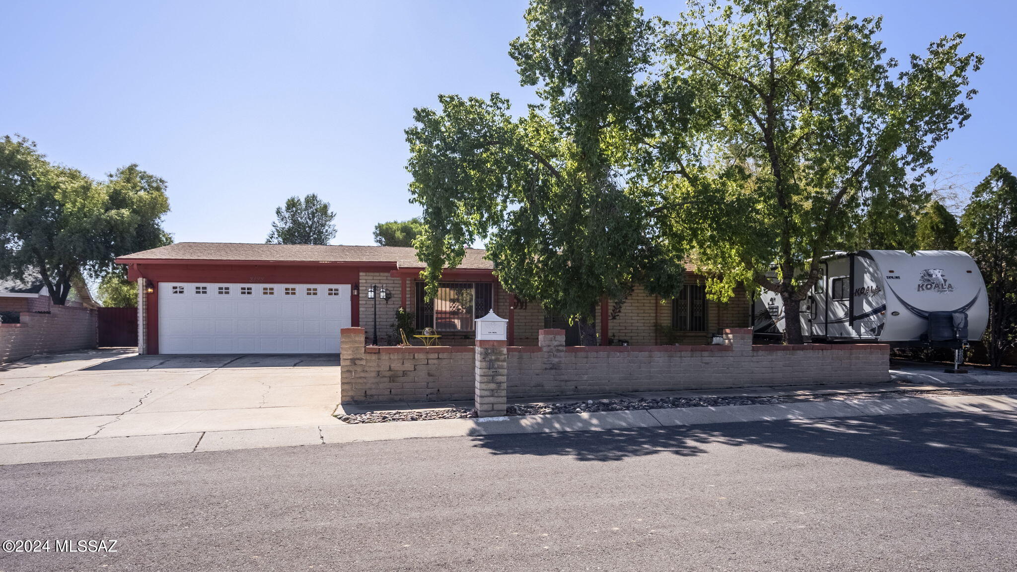 Ready to fall in love with peace, quiet, and elegance?   Here is a move-in-ready 4 bed/2 full bath+ family room on a .26 acre lot. It has concrete sidewalks, large mature trees, and a low-care front and rear landscaped yard.  It offers a formal dining area off the kitchen and a spacious living room with impressive natural light and a wood-burning fireplace.  The entertainer's kitchen offers custom white cabinets with pull-out drawers, an oversized island with cabinets, gorgeous granite countertops, bar seating, stainless steel appliances, and custom tile backsplash.   The family room makes a great entertainment room perfect for the whole family. It has many other great features such as upgraded light/plumbing fixtures, laminate floors, upgraded ceiling fans, rod iron front door, more* french doors, built-in shelves, recessed lighting, under-mounted sinks in the bathrooms, and spacious bedrooms.   Enjoy peaceful Tucson nights from inside the Arizona room/extended covered patio.  The other option is to step outside onto your large private backyard area, sit in the built-in ramada and enjoy Tucson's pleasant evenings.  Conveniently nearby shopping, restaurants, and banking.  Don't miss the opportunity to own this beautiful home. Contact us today to schedule your viewing!