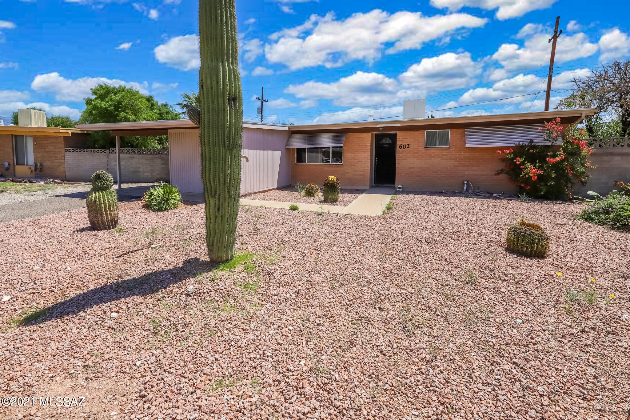 Lovely 3 bedroom-2 bath home. Kitchen-Dining Room-Living Room. Large Laundry Room/Office Space. Large Carport-Storage Shed stays. Large backyard that backs up the a wash. Double gates allow to drive in carport and out of yard into alley at the wash. Lots of animals travel through the wash.