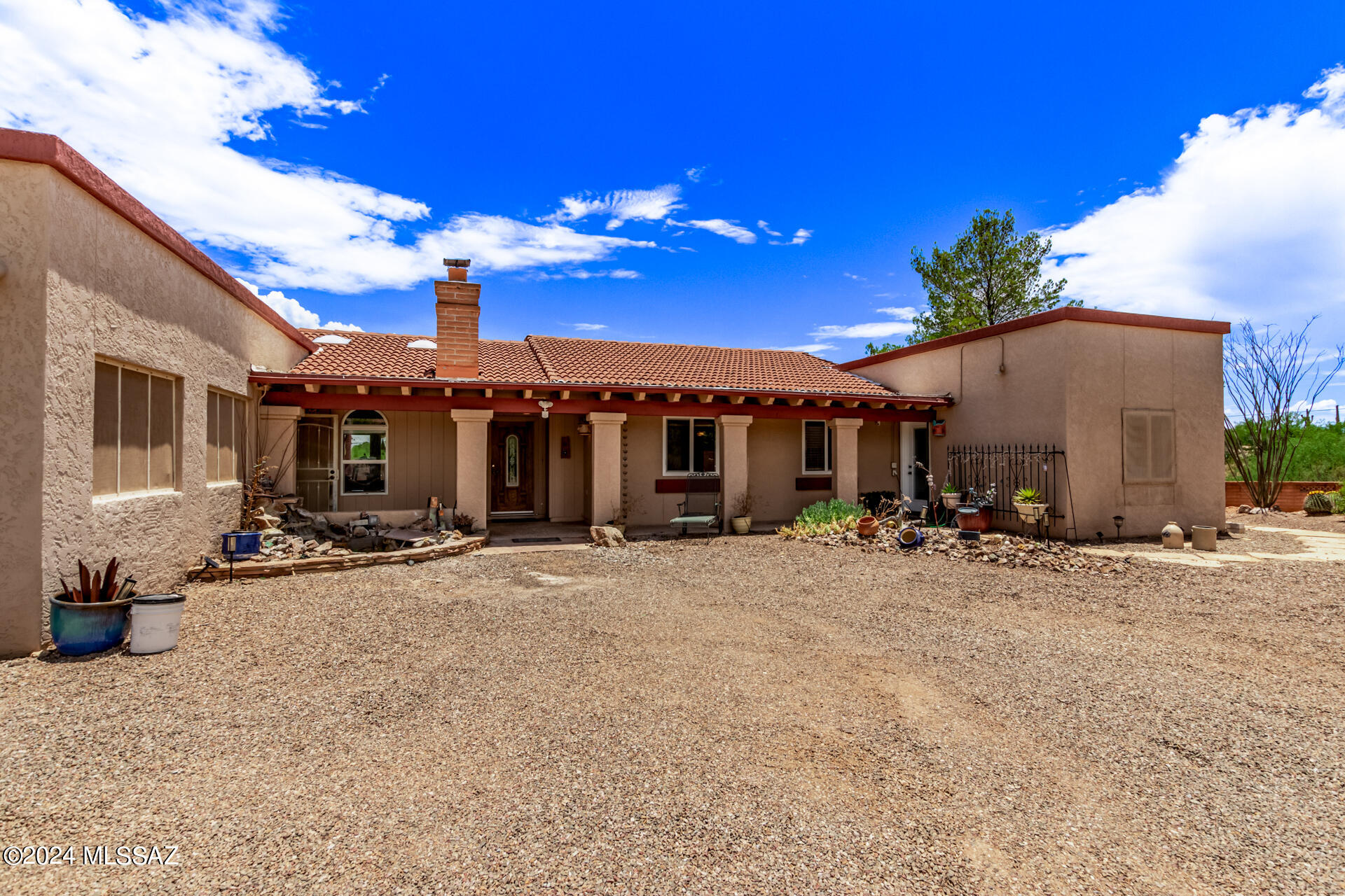 This property has lots to offer & is a MUST see! With 1.43 acres of land featuring amazing views, untouched land including a natural wash, plenty of desert landscaping and wildlife.Kitchen features stainless steel appliances including 2 oven range & pull out drawers. The island has 13 pull out drawers & a raised breakfast bar. It sits under a Farm style overhead light fixture. Laundry room/pantry is off the kitchen w/shelves for storage & a full size freezer that stays. Dining rm has built in hutch & two sliding glass doors to the patio. Spacious primary bedroom with a beautiful ensuite bathroom featuring a walk in shower. Don't forget to take a peek in the backyard with an outdoor shower and more!