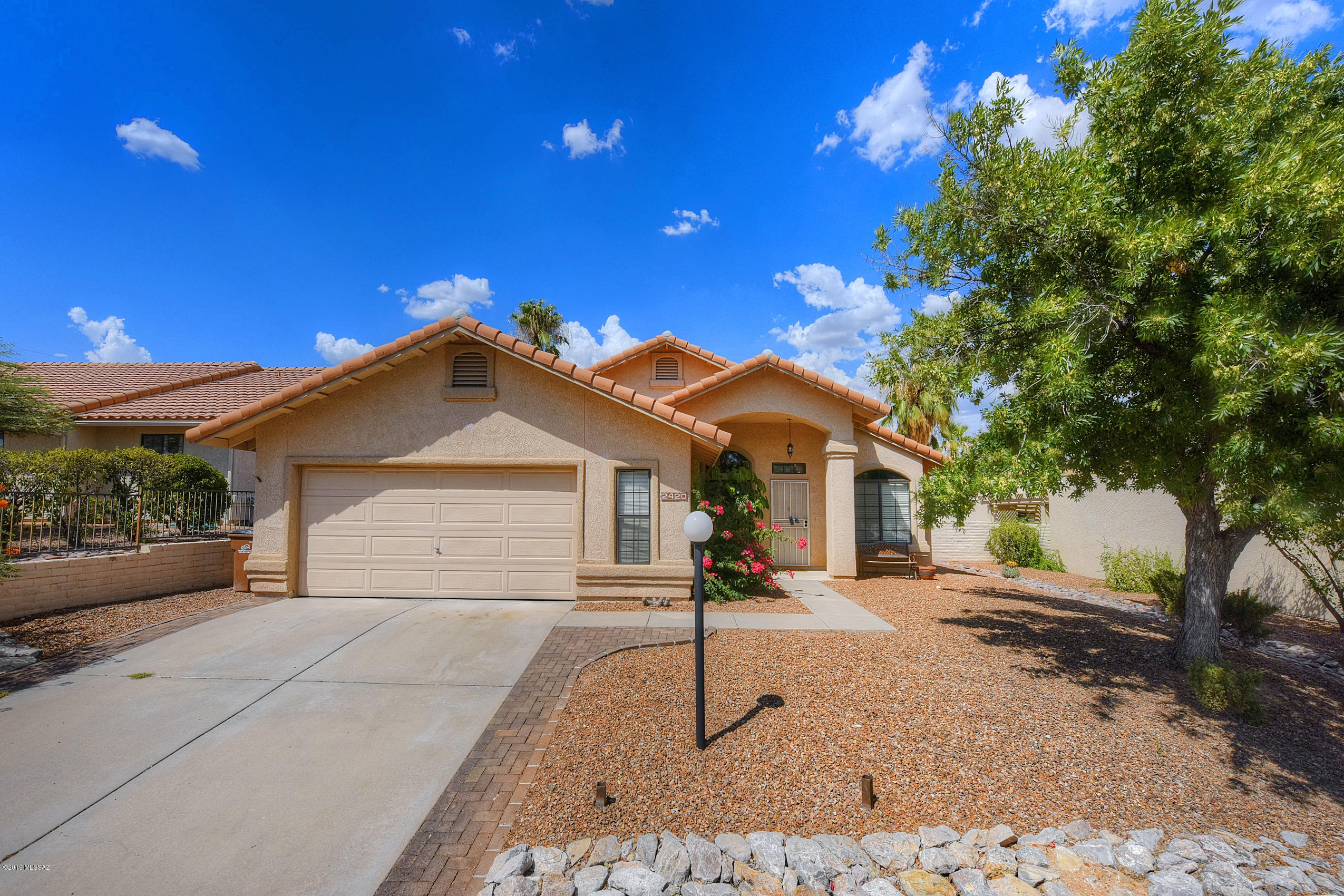 Beautiful, completely remodeled in a Northwest Gated community.  Formal living and dining room with office/den!!! Family room with cozy fireplace and open kitchen.  New, stylish tile throughout with fresh carpet.  Both bathrooms updated with designer touches. New vanities, toilets, pattern floor tiles and herringbone pattern tile in showers & tub surrounds.  Elegant kitchen with lots of cabinets, large island with granite counter tops, new Samsung gas stove, dishwasher, microwave & refrigerator.  2 car over-sized garage with plenty of storage. Good sized yard with mountain views and privacy.