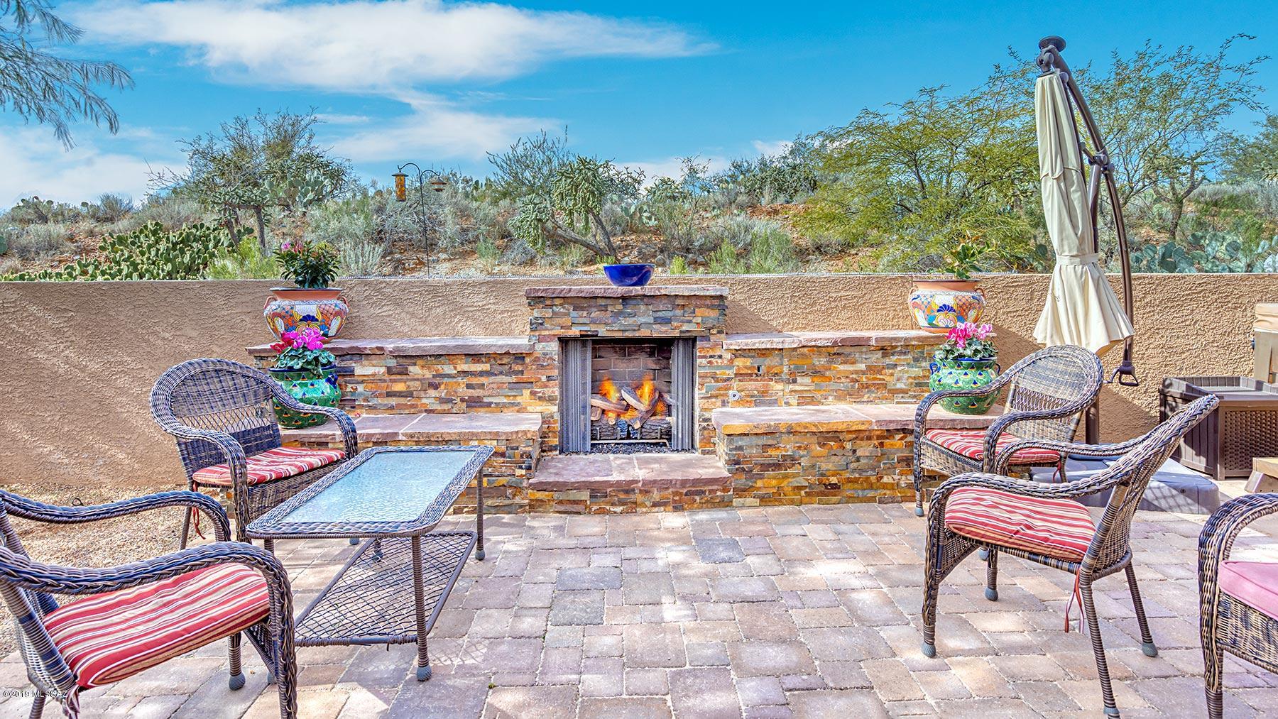 Entertainer's oasis awaits you in this highly upgraded Palacia model w private casita. The paver drive & walkway, mature landscaping & lighting welcomes you. Upon entering you are drawn to the view of the natural desert setting framed in the large picture windows of the living/dining room. 3 solar powered skylights enhance the indoor/outdoor feeling. Updated kitchen w stainless appliances, corner sink, solar tubes, plenty of cabinetry & granite counters opens to nook & family room. Master suite w slider to private patio, plus en-suite w double sink vanity, shower & walk-in closet. Den/office can double as guest room. Outside, the expanded paver hardscape & ramada draws you to the inviting fireplace w open desert beyond. Spacious casita awaits your guests. Come see the best of SaddleBrooke.