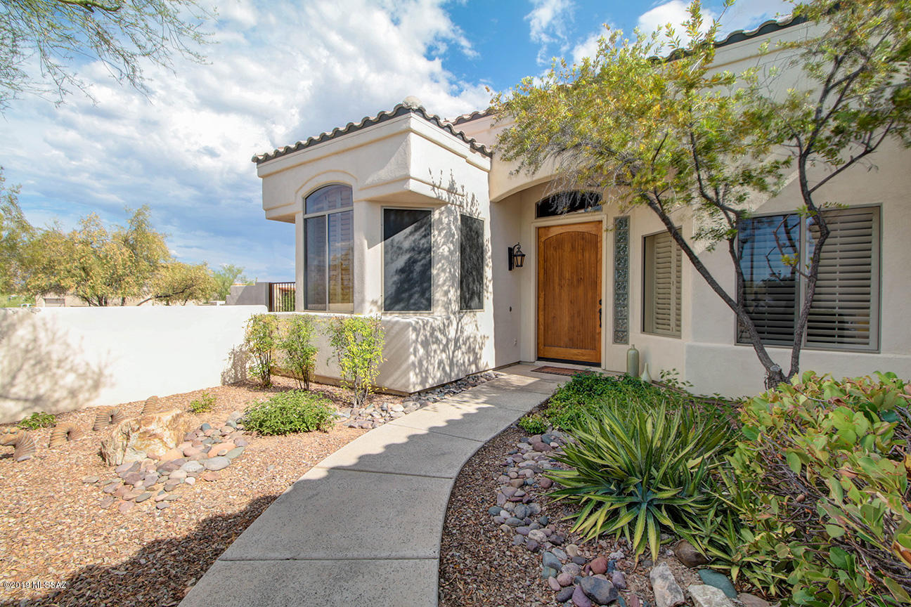 BACKYARD SANCTUARY w/ fruit trees, raised garden bed, pathways & low maintenance landscaping situated outside the PICTURESQUE Saguaro National Forest w/ IDEAL HIKING opportunities yet CONVENIENT TO DOWNTOWN for some unique Tucson action. RELAXING & Dreamy Outdoor screened-in sitting patio w/ atmospheric lighting & fans. Get the true desert experience while keeping cool! Backyard awaits!! NO DEED RESTRICTIONS allow you to built your dream pool area & RV parking for any needs. STYLISHLY UPDATED interior w lots of natural sunlight, specially-made curtains, high ceilings, recently remodeled master bathroom & a den with CUSTOM shelving. Cozy fireplace seating area compliments the open floorplan & UPSCALE kitchen to encourage some fun ENTERTAINMENT opportunities!