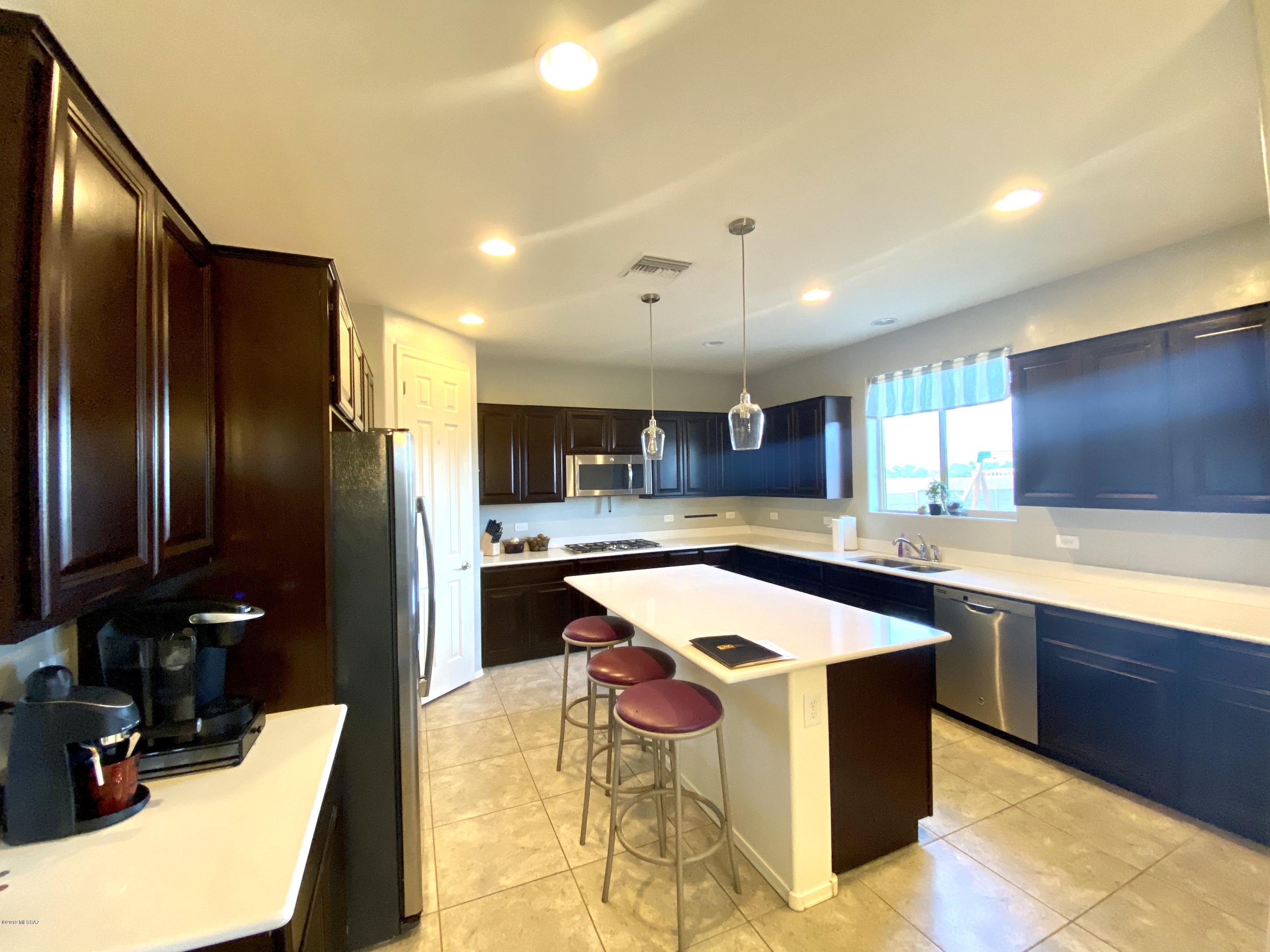 Desirable location in the Vail School District.  This home's kitchen is a cook's dream with upgraded cabinets, double oven, and white quartz countertops.  The living room offers plenty of room for family time and entertaining guest. With four bedrooms, three bathrooms, a large loft upstairs, and a large child's playground in the backyard, this home is perfect for a growing family. There are beautiful mountain views from the master bedroom's window along with a sitting room in the master bedroom.  The master bedroom even has a fireplace for cozy nights! Home is already equipped with solar panels making the home both economical and environmentally friendly. Come take a look at this home!