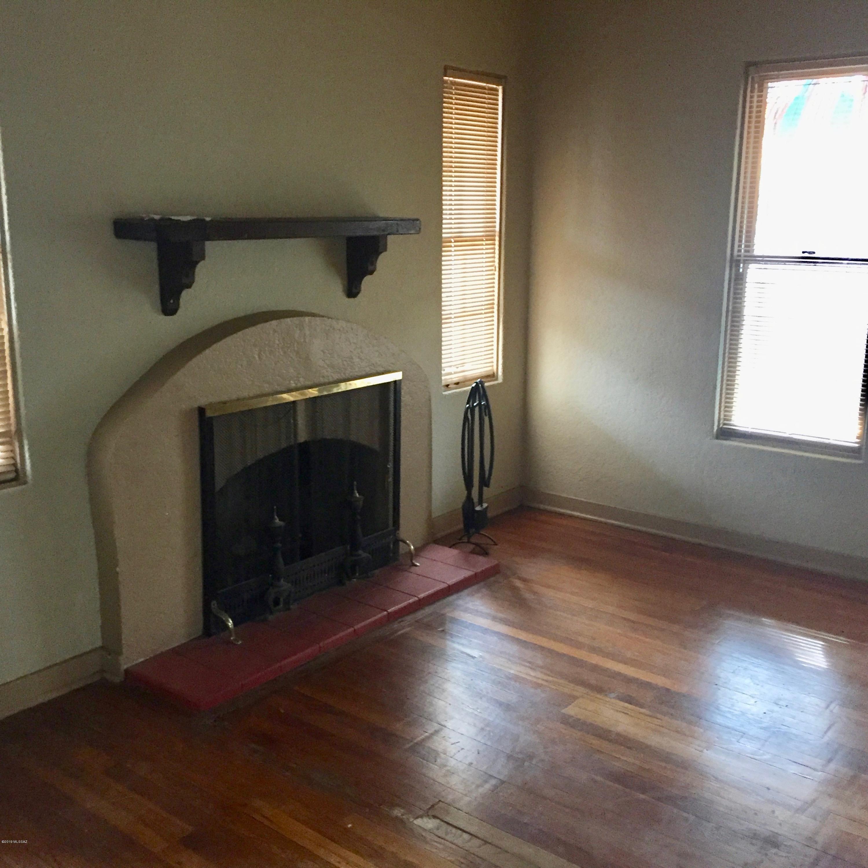 Historic Sam Hughes home as original charm, with wood flooring, fireplace in LR.  Gas range, W/D in outside storage area, large enclosed yard.  Driveway parking