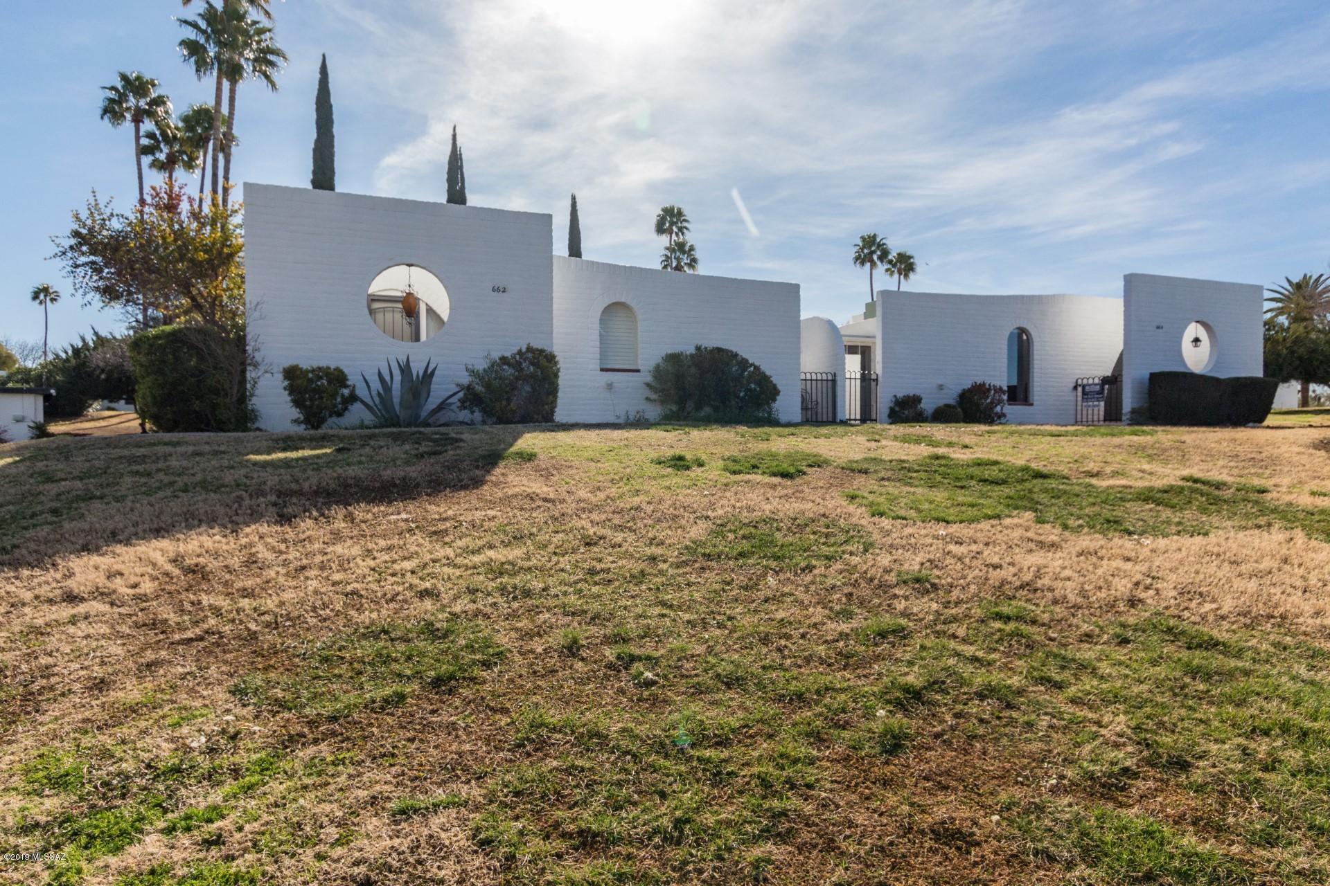 Retreat from the city to this cozy adobe casita nestled in a secluded garden oasis.  Tastefully updated and full of charm this home sits atop a knoll which overlooks the pool area along with mountain and city light views. 55+ Community.  Clubhouse, 2 pools, and tennis courts.  Close to shopping, dining, bus, and medical facilities.  HOA includes water, trash, sewer, outside insurance and maintenance. Adobe Brick.  Built by renowned Architect Bennie Gonzalez.