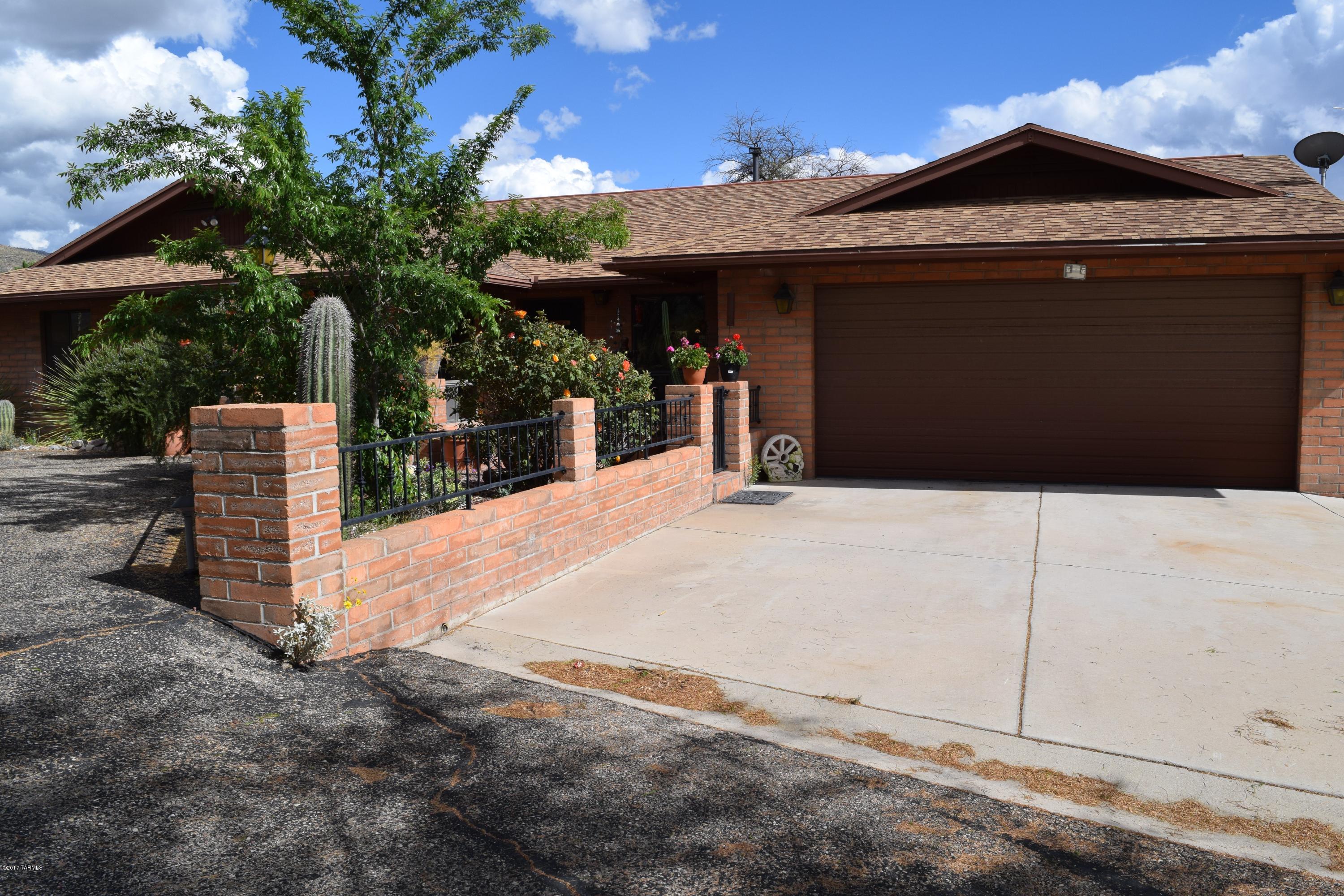 WELCOME HOME! Diamond in the rough and incredible something for the whole family. This home is perfect for any family, 4 bedrooms, 2 bathrooms, formal living, dining open kitchen and family room with fireplace. Beautiful Saltillo Tile and carpet throughout the home.  The views will WOW you from the full length back covered patio. The entertaining possibilities are endless. 2 car garage attached to the house and 3 car detached fully insulated including a workshop.