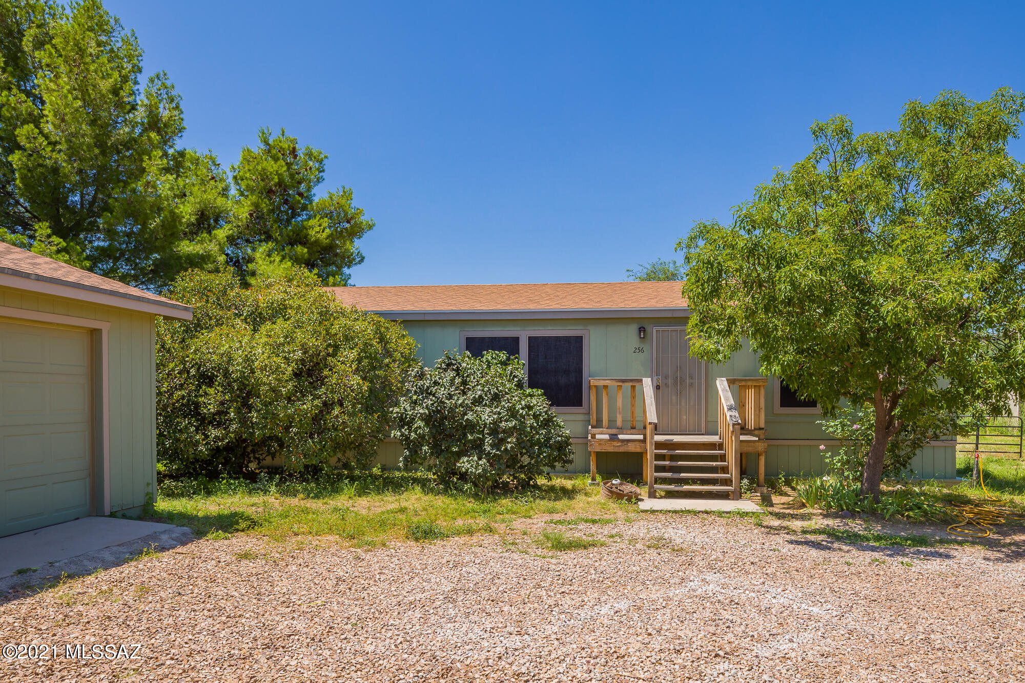 3 Bedroom 2 Bathroom Manufactured home on over an Acre. Freshly painted interior, with beautiful laminate flooring throughout ready for new owners to make their own. This lot is zoned for horses. 2 Car detached garage adjacent to home.