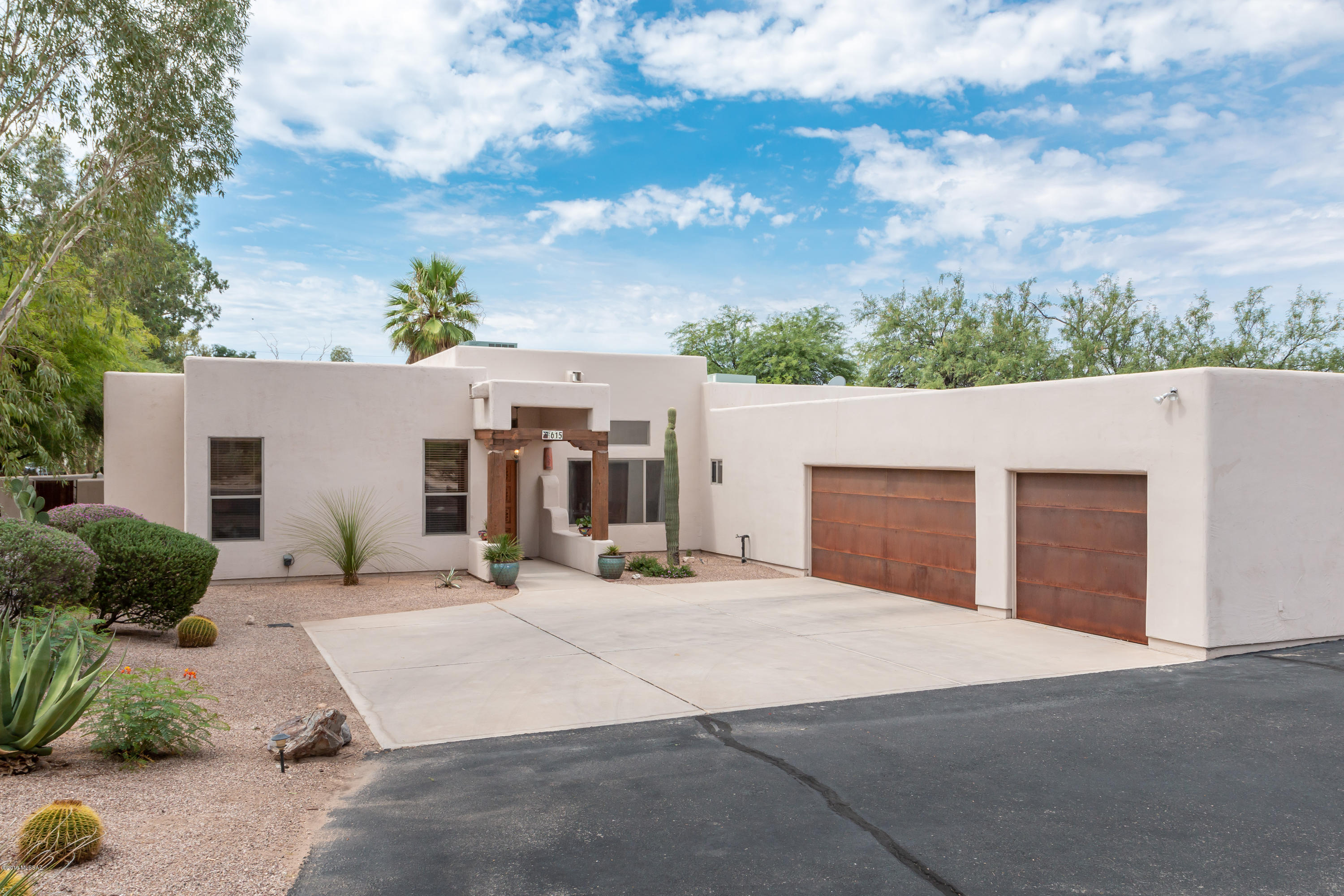 No HOA.  First time on the market - don't miss this!  ''Winner of the TAR Home Tour.''
It's a one of a kind Contemporary/Southwest custom built home, designed by Architect Gary Robison, and located in Casa Adobes on .83 acres.  It has 4 beds, 2 ½ baths, 2,512 sq.ft., an open floor plan, centrally designed kitchen with island, a conventional pool with security fence and an oversize 3 car garage.   Interior features show accents of lodge pine wood and wooden beams, 20'' tile flooring, a split bedroom plan, lots of windows plus 3 skylights to bring in natural light.  The kitchen has been remodeled with rich cherry cabinets, stainless steel appliances, a center island for easy cooking and gorgeous granite countertops. The remodeled master bathroom and ½ bathroom have quartz countertop and custom built cabinets; the ½ bathroom has access to the pool. The large laundry room includes a utility sink. The oversized extended 3 car garage has space for a workshop and lots of extra storage. The backyard is very private with huge mature plantings and Eucalyptus trees. There is additional land beyond the pool wall.  Fantastically located... only minutes away from restaurants and shopping.    An easy commute to downtown, The University, Oro Valley and 10 minutes to I-10. This is a find! Move in Ready. Must see!