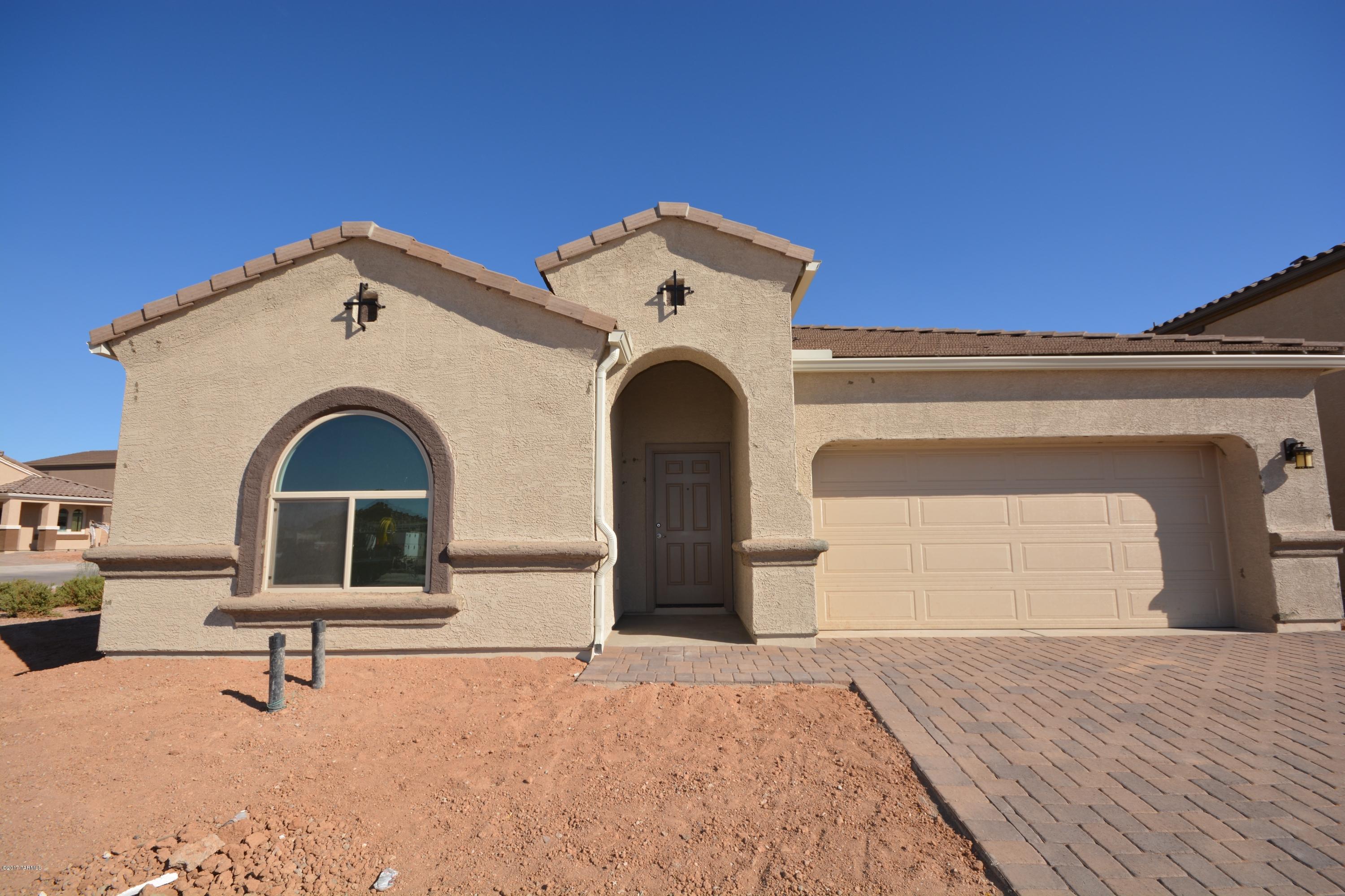 Saguaro Bloom Phase 2! Going quickly - tremendous views and the same amenities and accessibility as Phase 1. This is our very popular Prato Plan! This flexible floor plan can be 3-5 bedrooms depending on configuration.   We have selected 3 bedrooms with a den and dinning room that can also double as an office or playroom with 2 1/2 baths.  Split floor plan with an open great room and vaulted ceilings complete with wood plank tile, staggered white cabinets and upgraded granite!  Brand new construction Energy Star Qualified Home - with a builder warranty.  AMAZING VIEWS of saguaro studded cliffs and amazing sunsets from this perimeter lot. Currently under construction this home will be available by the end of May.