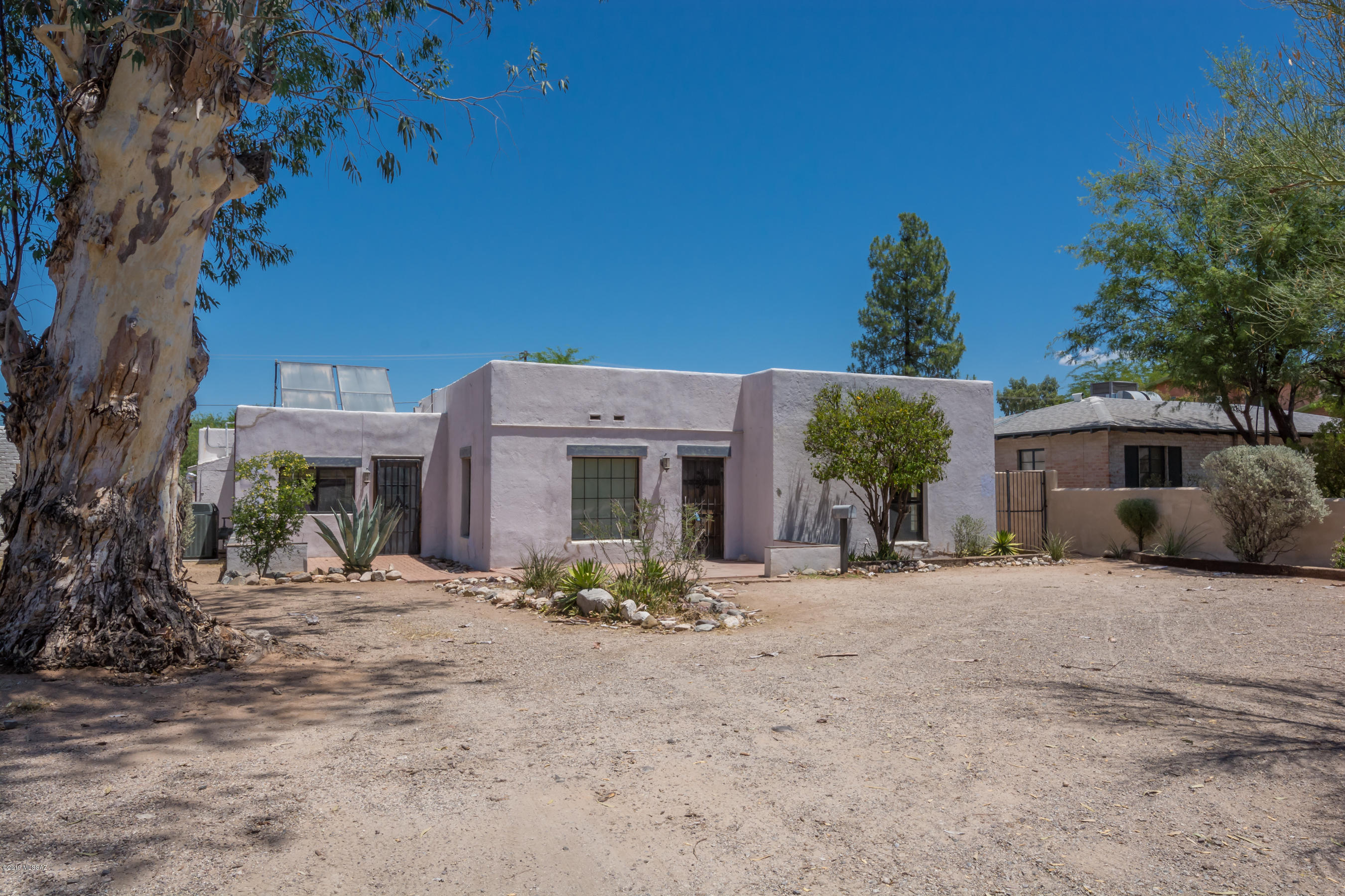 This well placed home was originally built in 1937 and it retains some of its Historic character. It was enlarged in 1959 and a permitted guest house was added in 1975.  It is expansive and roomy. This serene home is on the historical registry. With 5 bedrooms, a den and an activity area and 4 bathrooms, it has a very flexible floorplan.  Dual pane windows are one of the modern touches.  The guest house has a newer HVAC (2017) .  It has several yard spaces that add to its charm.
