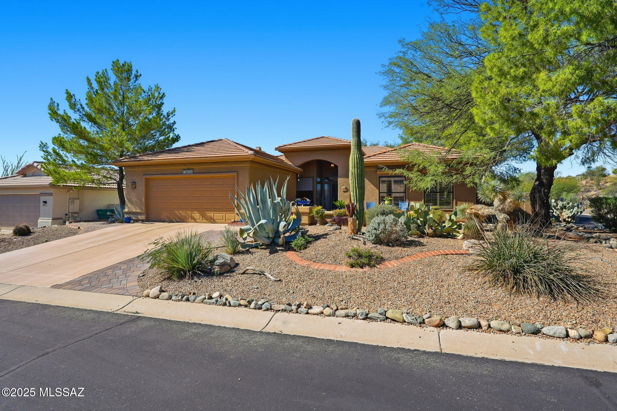 Welcome to this well-appointed Madera model located at the end of a very quiet street on a nicely sized corner lot. Enter through a charming, gated courtyard with flagstone flooring. The kitchen shines with granite countertops, complimentary backsplashes, GE stainless steel appliances & sink, knotty alder cabinets w/hardware, 20'' tile, pendant lighting and features an adjacent sunny breakfast nook w/custom window treatments. Cozy family room includes a beautiful floor to ceiling stacked stone gas fireplace, perfect for the cool winter days! Beverage bar features granite counters, glass shelving and mirror. Spacious living room and adjoining dining area are ideal for entertaining. Primary bedroom offers a peaceful retreat with spa-style bath and generous closet space. Step outside to the extended covered patio w/ceiling fan and Kool Deck flooring, surrounded by lush landscaping, including a lovely rose garden, citrus trees, pavered side yard and an elevated seating area for mountain viewing. Stylish, comfortable and move-in ready home!