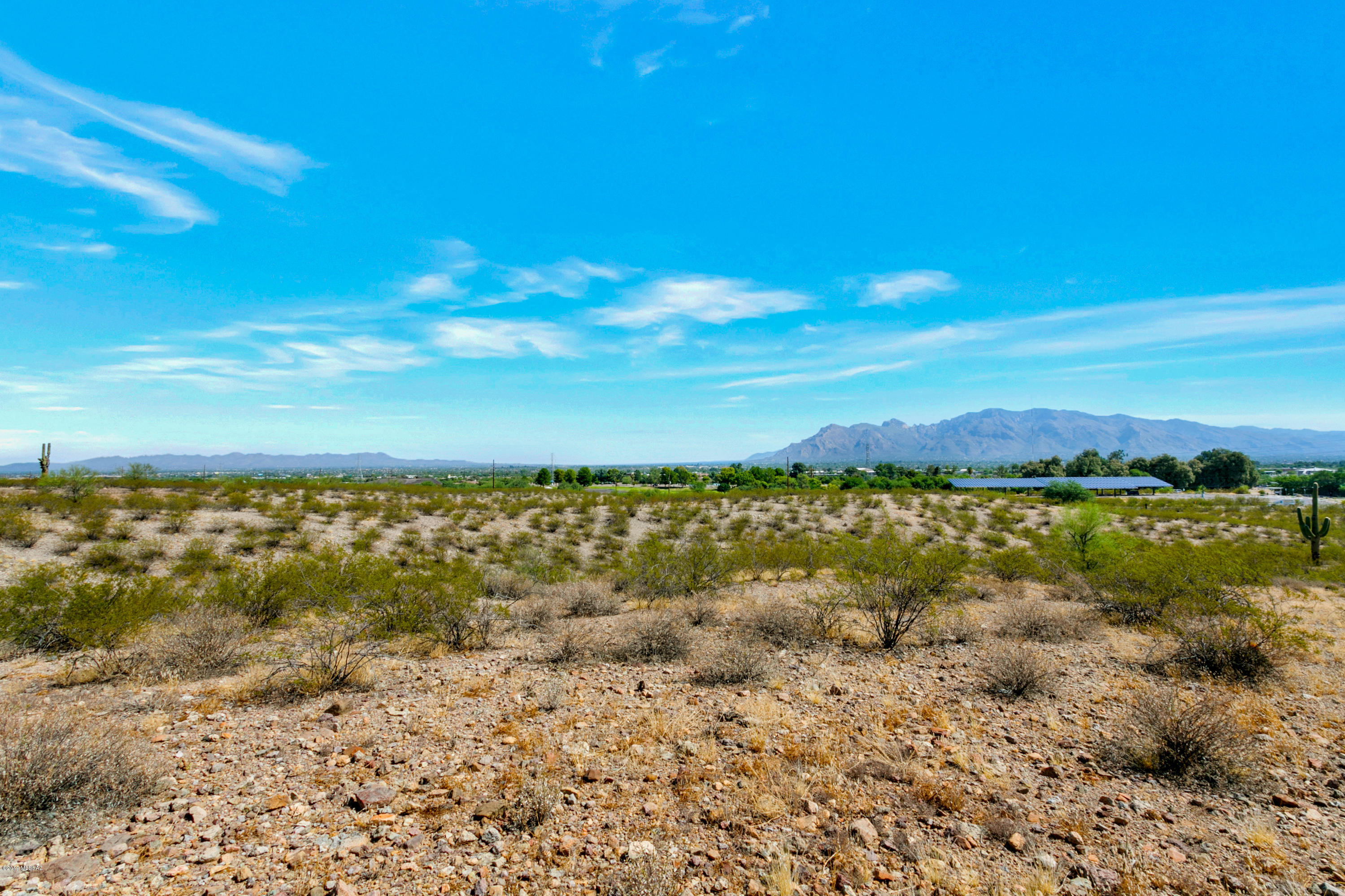 One of five spectacular west side SR lots with incredible views! LOCATION, LOCATION, LOCATION!! Private, serene, yet close to everything.  Accessible to so very much.... I10, shopping, medical services, transit lines, Christopher Columbus Park, Silverbell Golf Course, the Sweetwater Wetlands for birdwatching pleasure, Santa Cruz River for the Loop OR for glorious horseback rides! 
Incredible views of the mountains (multiple ranges), sunrises, sunsets and the City of Tucson. 
Seller is installing water stub outs & Minor Land Division is completed with Pima County.